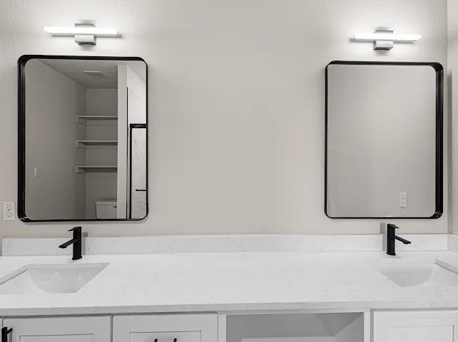 Bathroom featuring double vanity and toilet