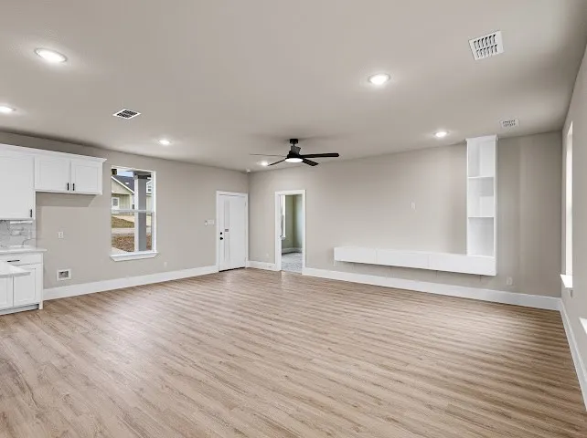 Unfurnished living room featuring light wood-type flooring, recessed lighting, and a ceiling fan