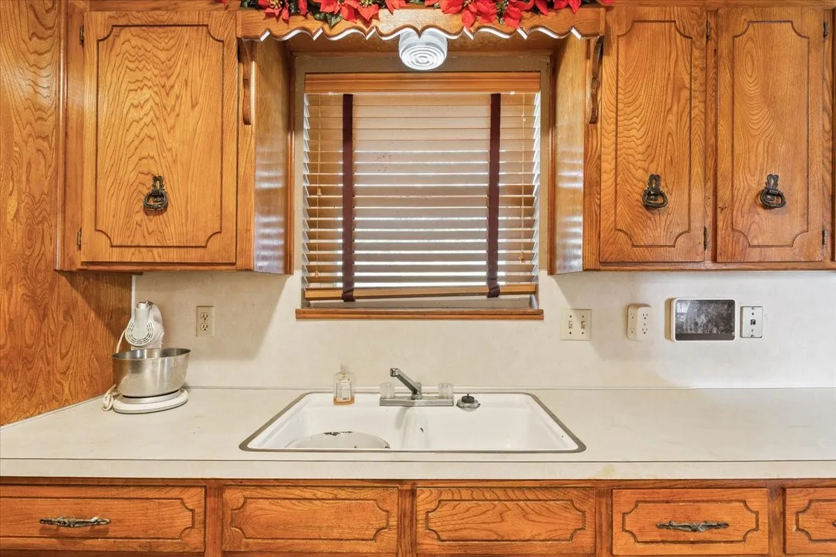 Kitchen with light countertops and brown cabinetry