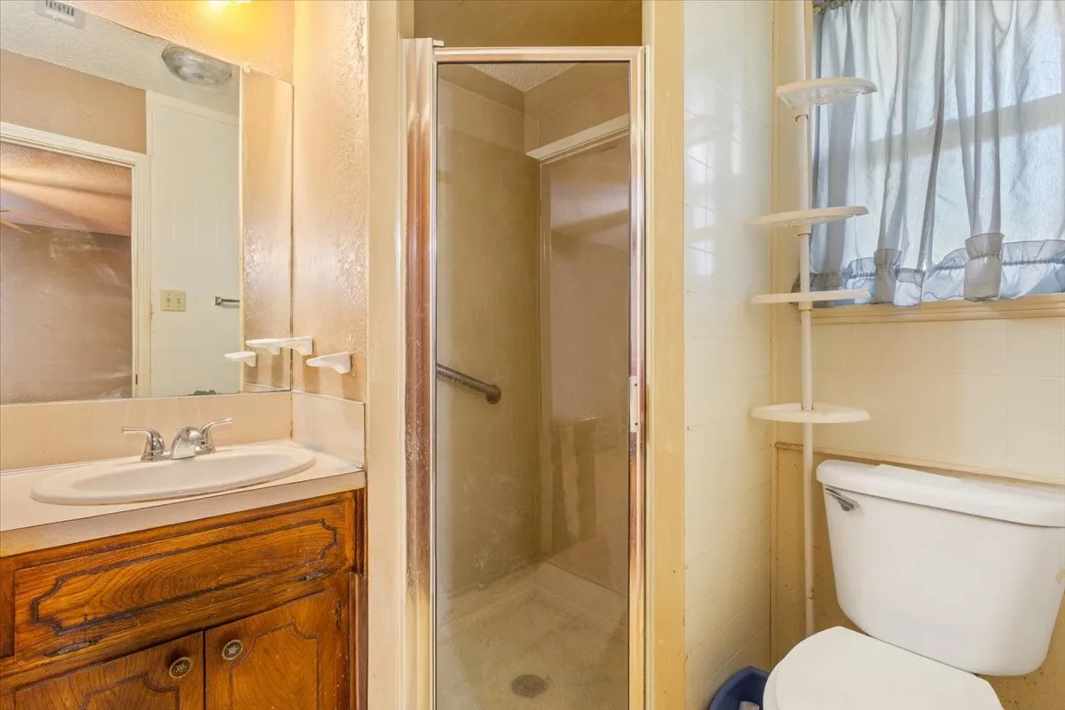 Bathroom featuring a stall shower and vanity
