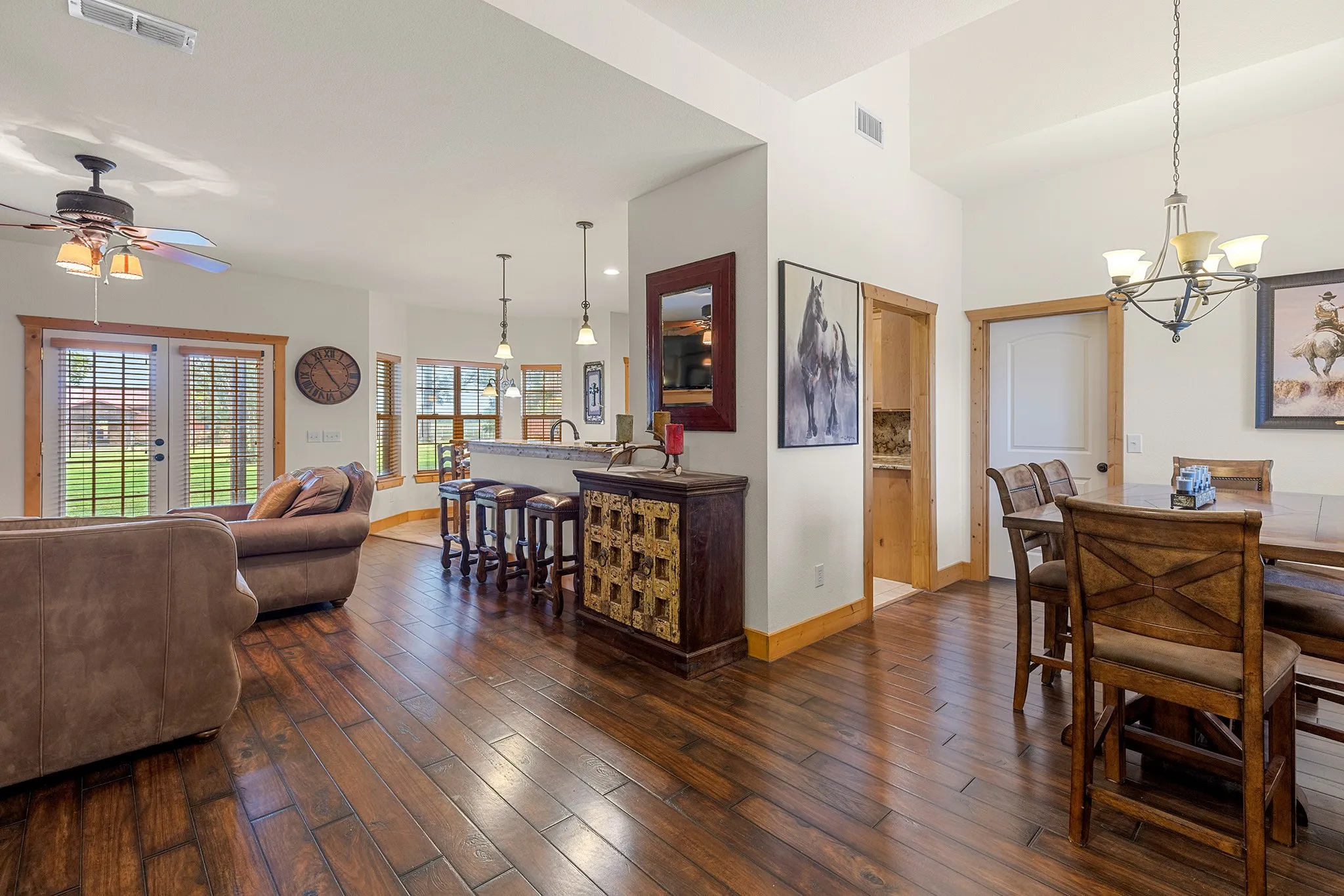 Dining room featuring dark wood finished floors, a chandelier, and ceiling fan