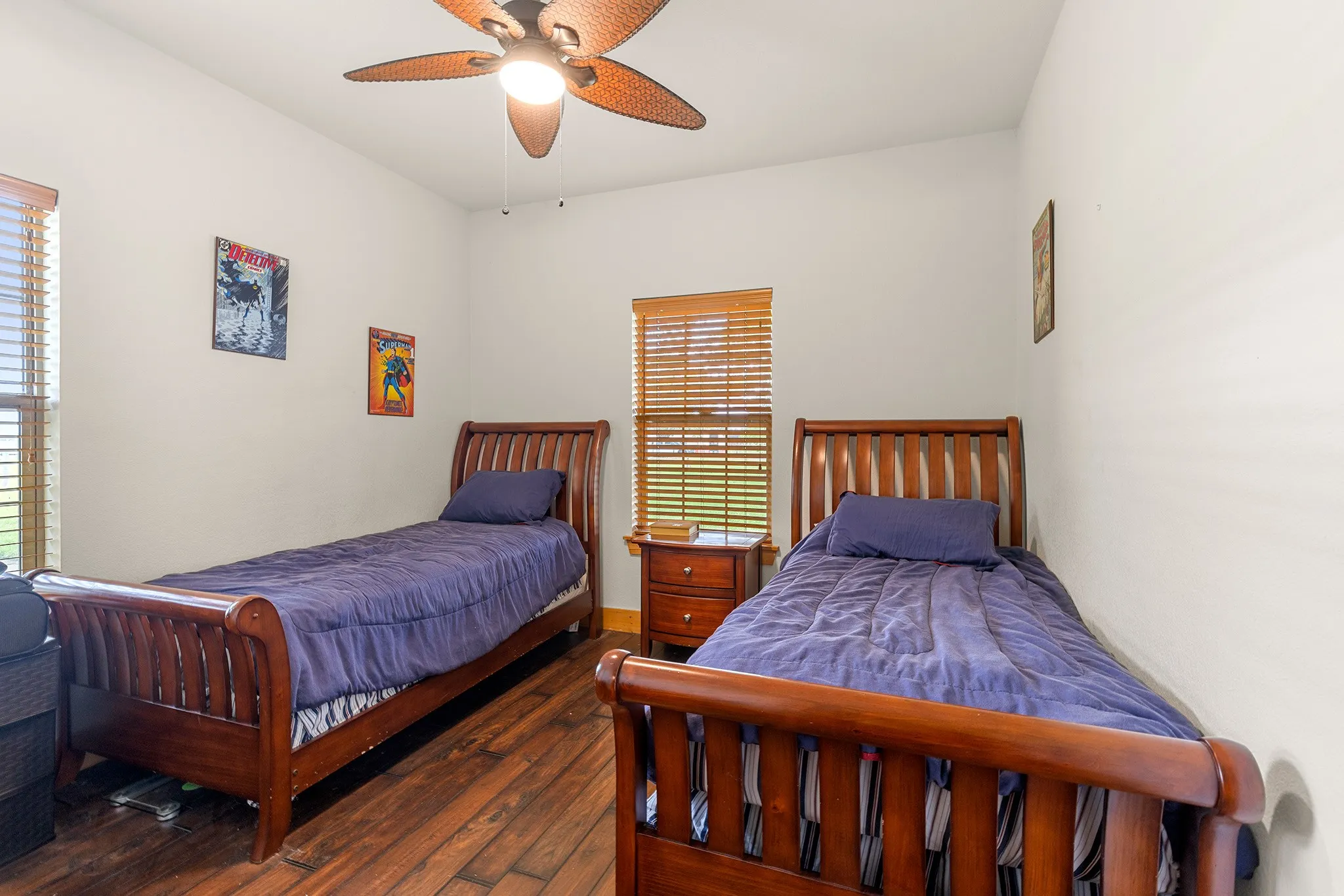 Bedroom with dark wood-style flooring and a ceiling fan