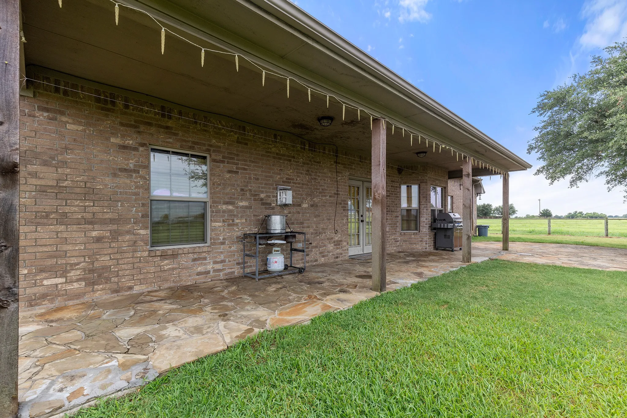 View of patio with area for grilling and french doors