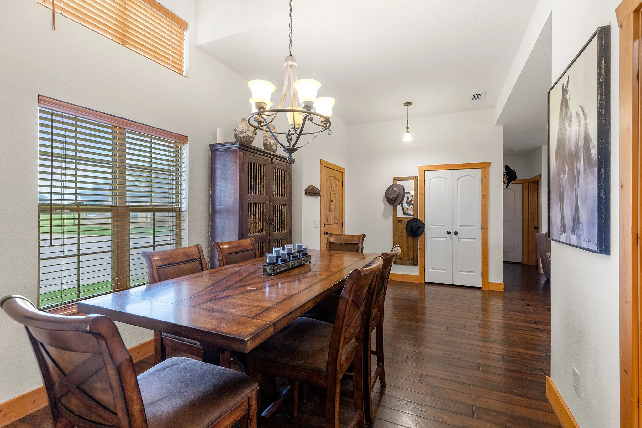 Dining room featuring dark wood finished floors and a chandelier