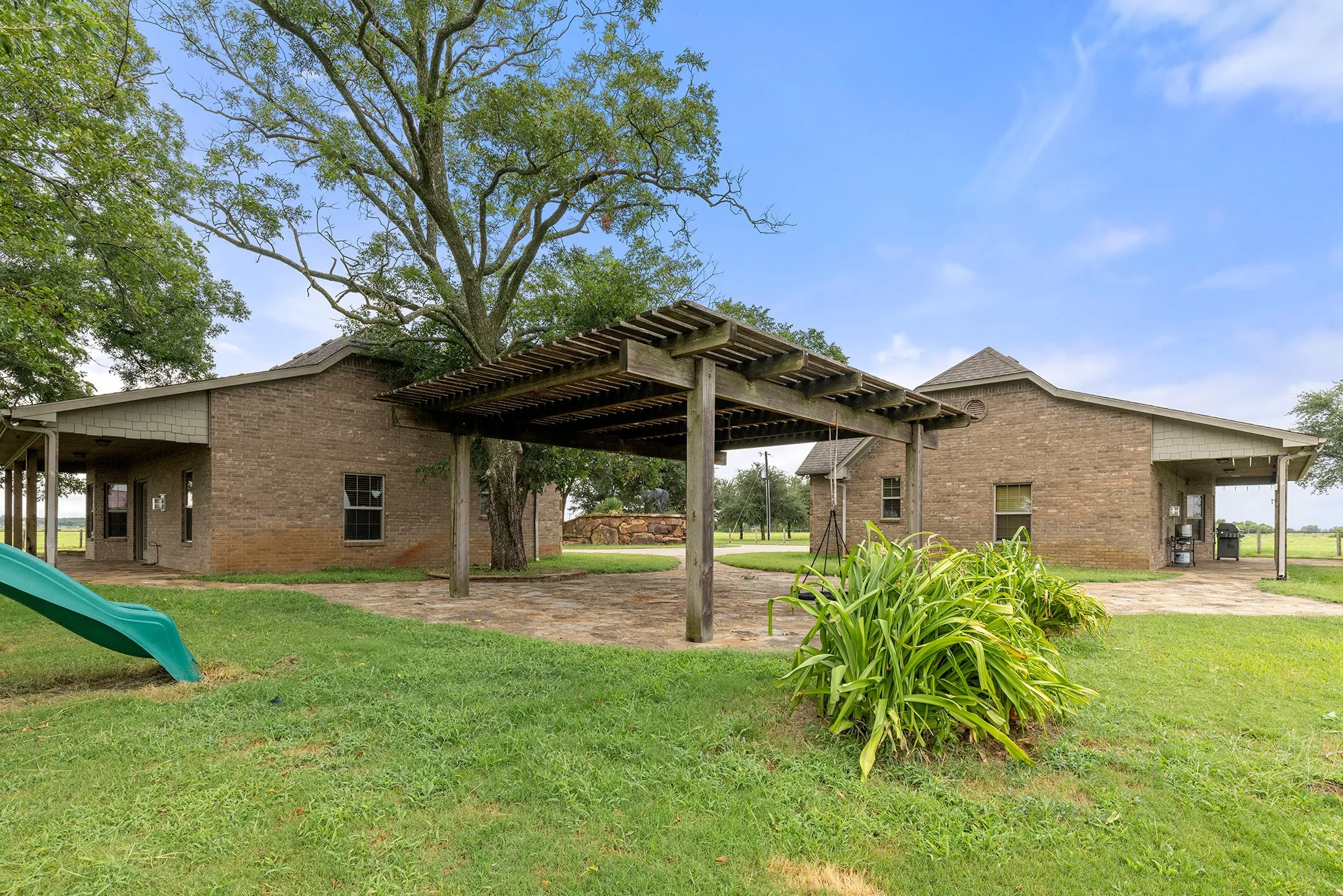 View of grassy yard featuring a patio area, a pergola, and a playground