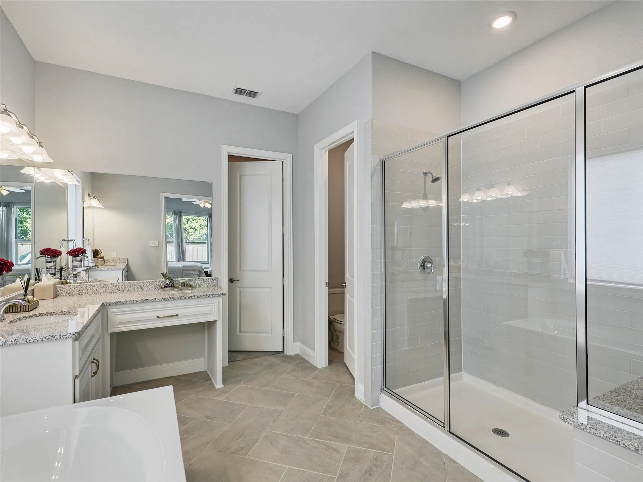 Full bath featuring vanity, a shower stall, and a bath