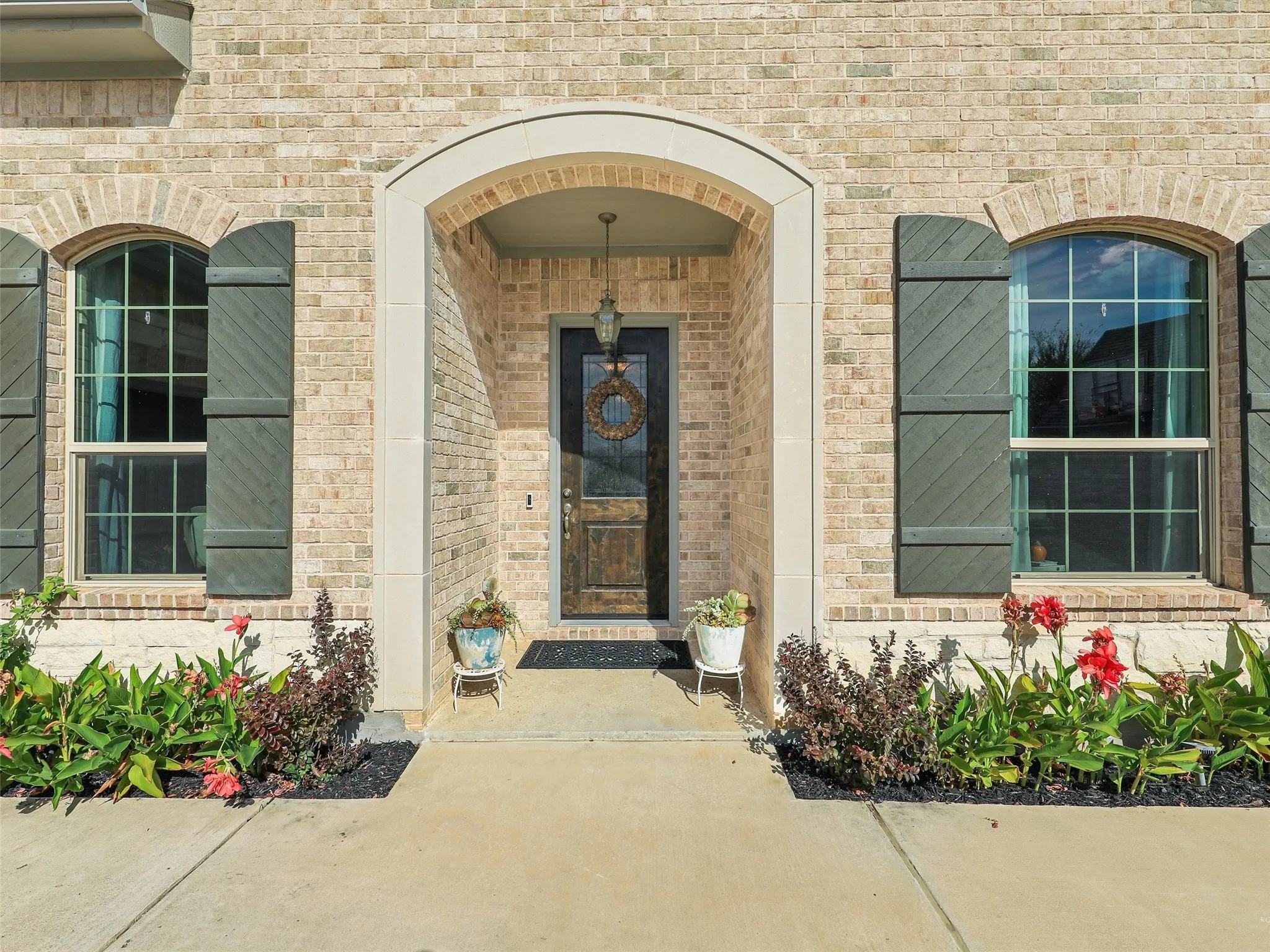 Property entrance featuring brick siding