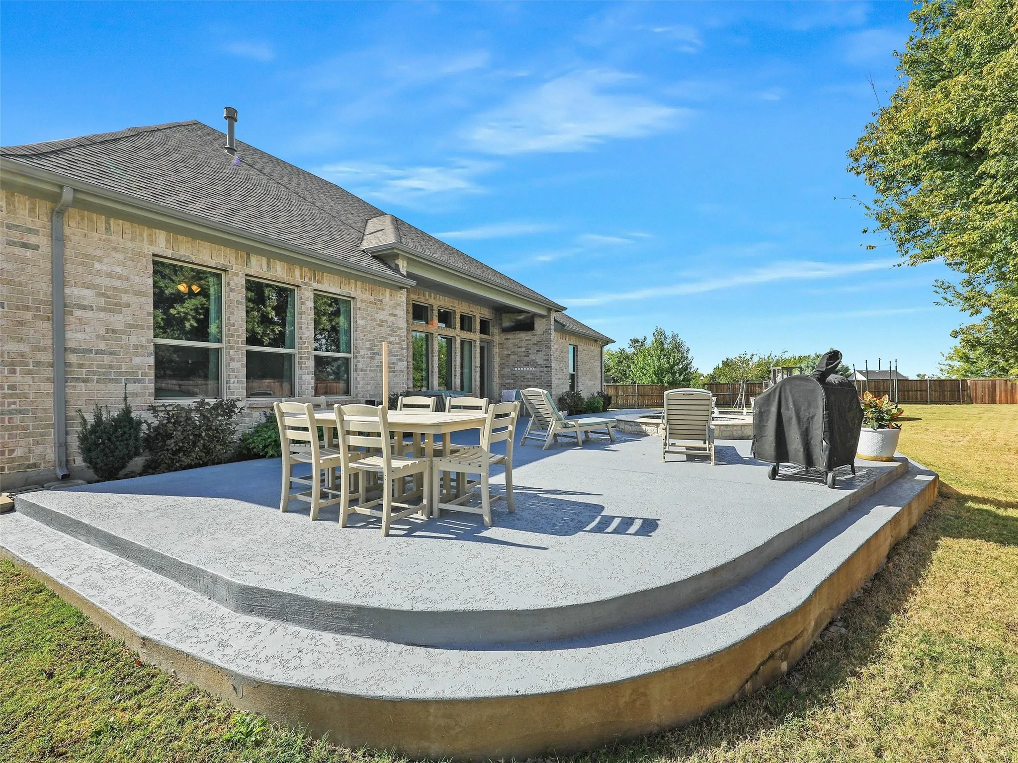 Fenced backyard featuring a patio area, area for grilling, and outdoor dining space