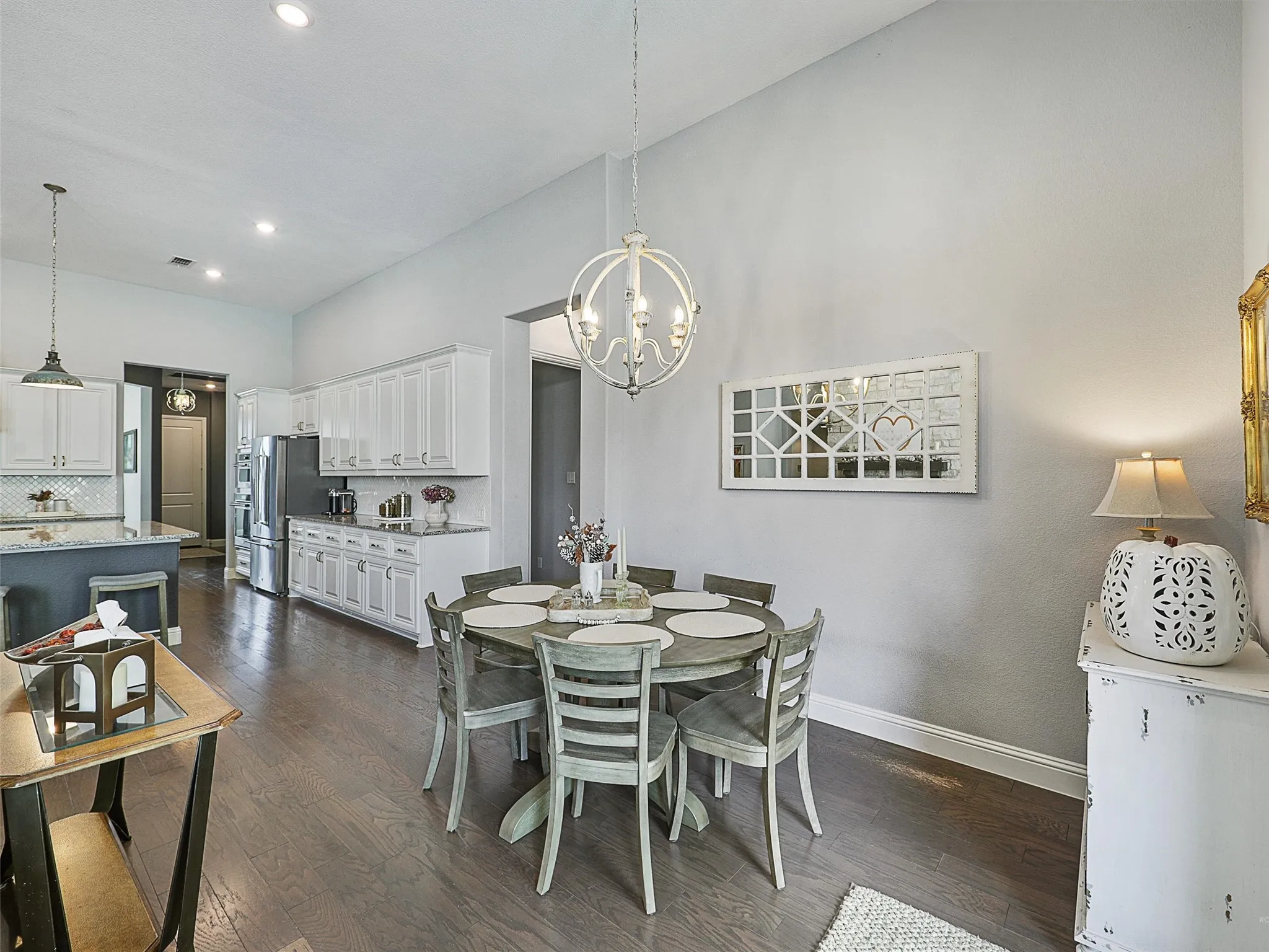 Dining space featuring dark wood-style floors, a chandelier, and recessed lighting
