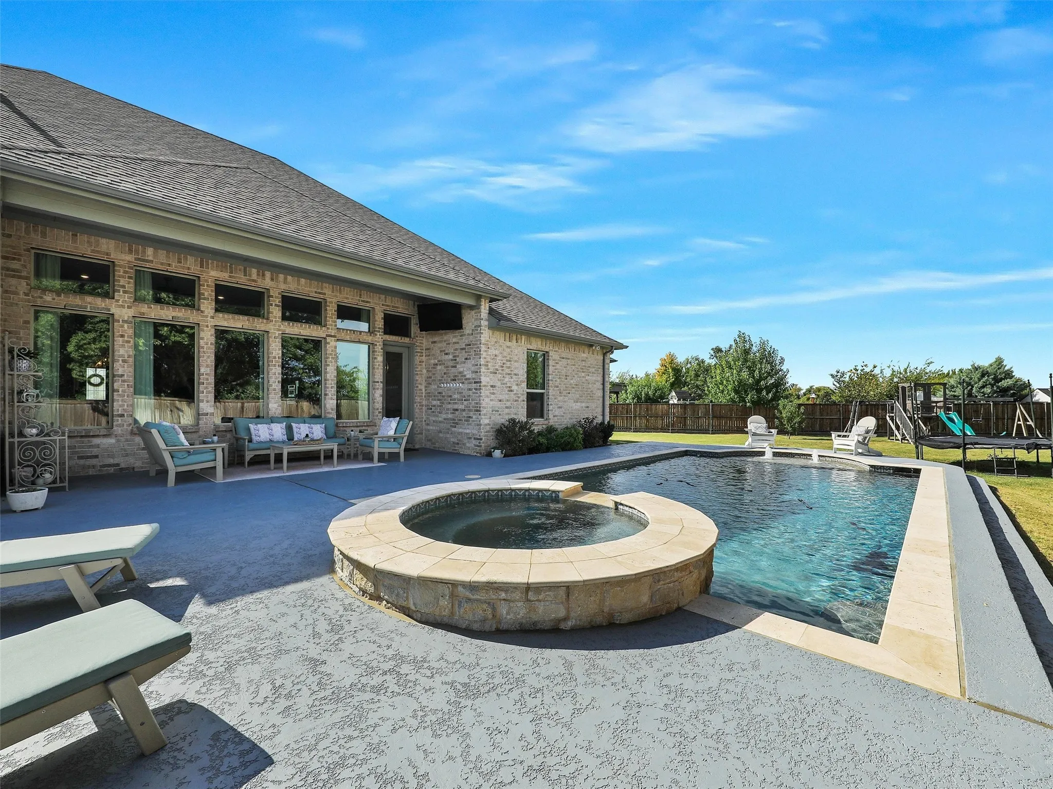 View of swimming pool featuring a patio, an outdoor living space, a fenced backyard, and a pool with connected hot tub