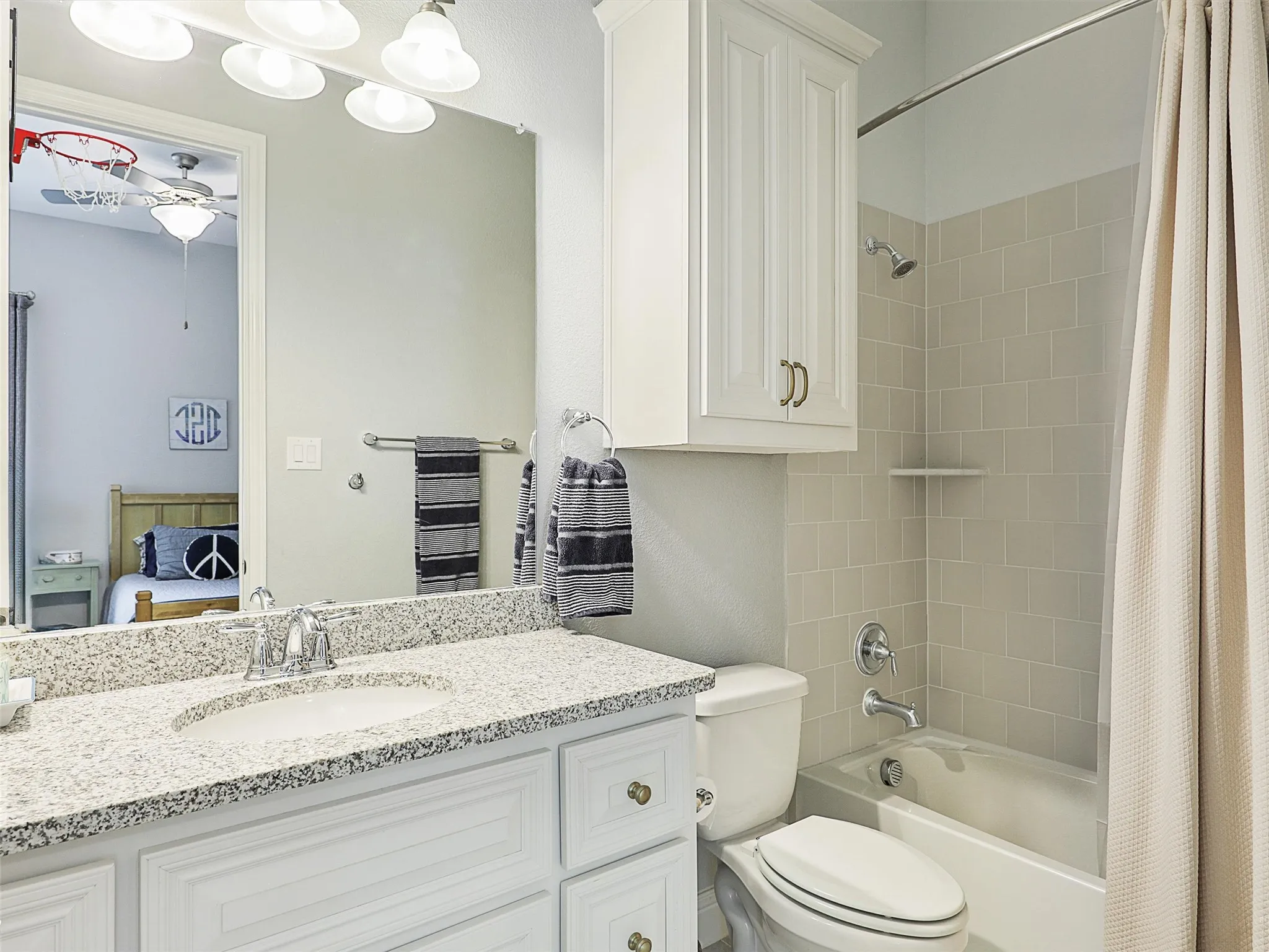 Bathroom with shower / tub combo, vanity, and ensuite bath