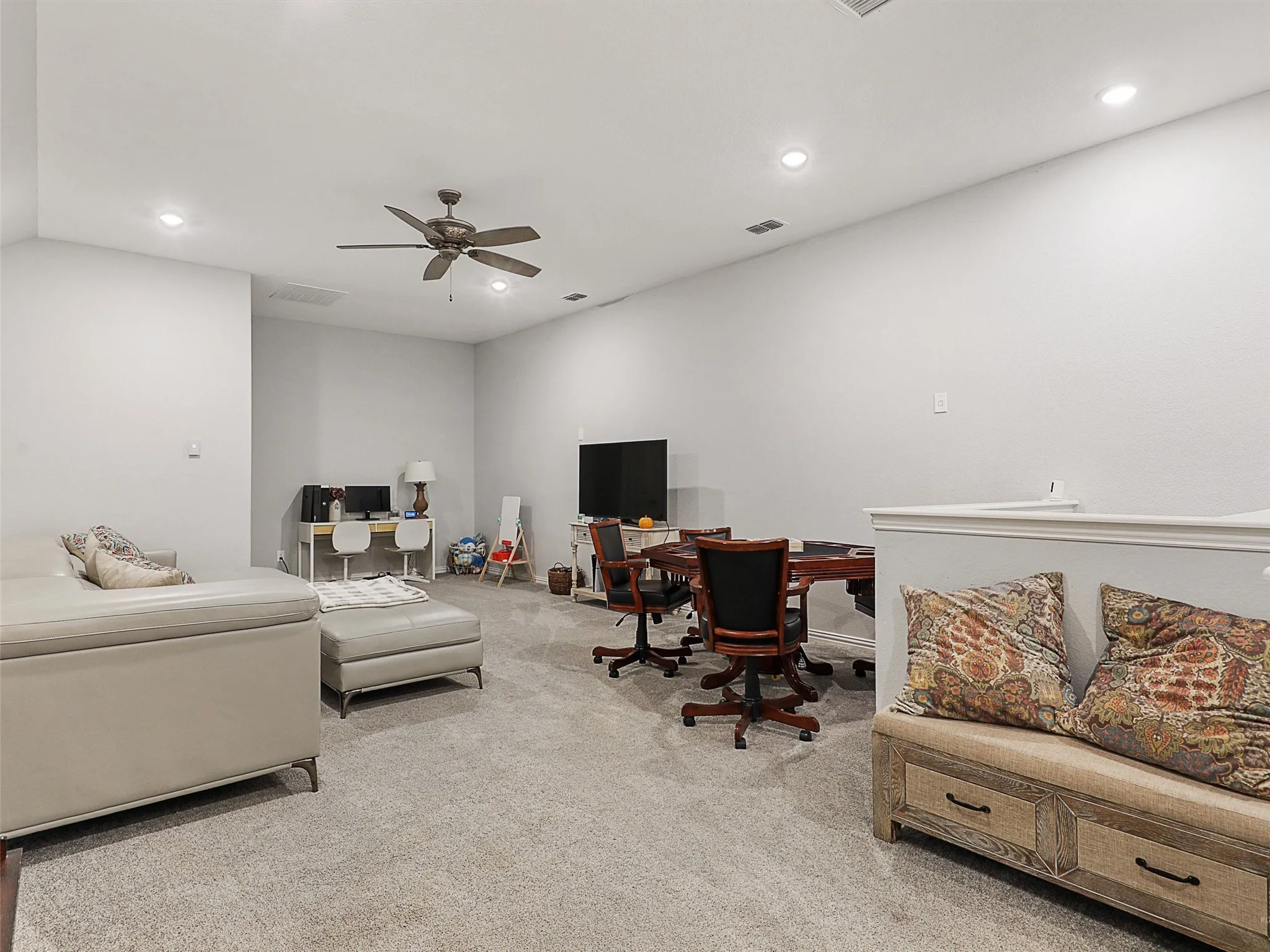 Living room featuring an office area, light carpet, recessed lighting, and a ceiling fan