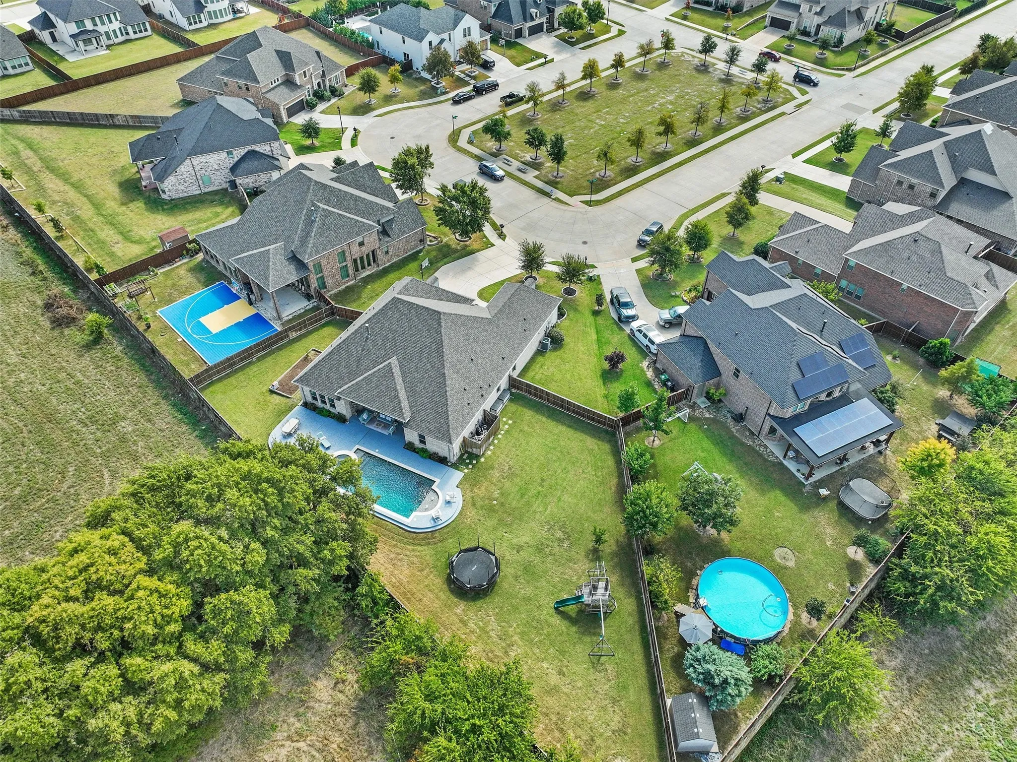 Aerial perspective of suburban area with a pool