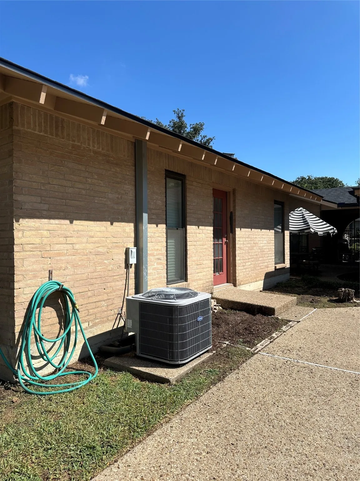 View of home's exterior featuring a cooling unit and brick siding