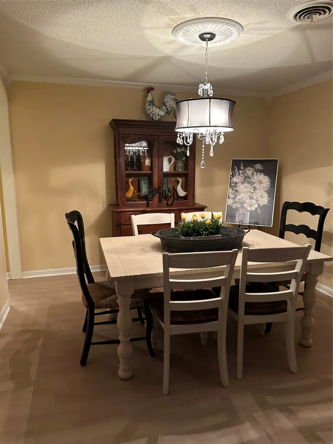 Dining space with ornamental molding and a textured ceiling