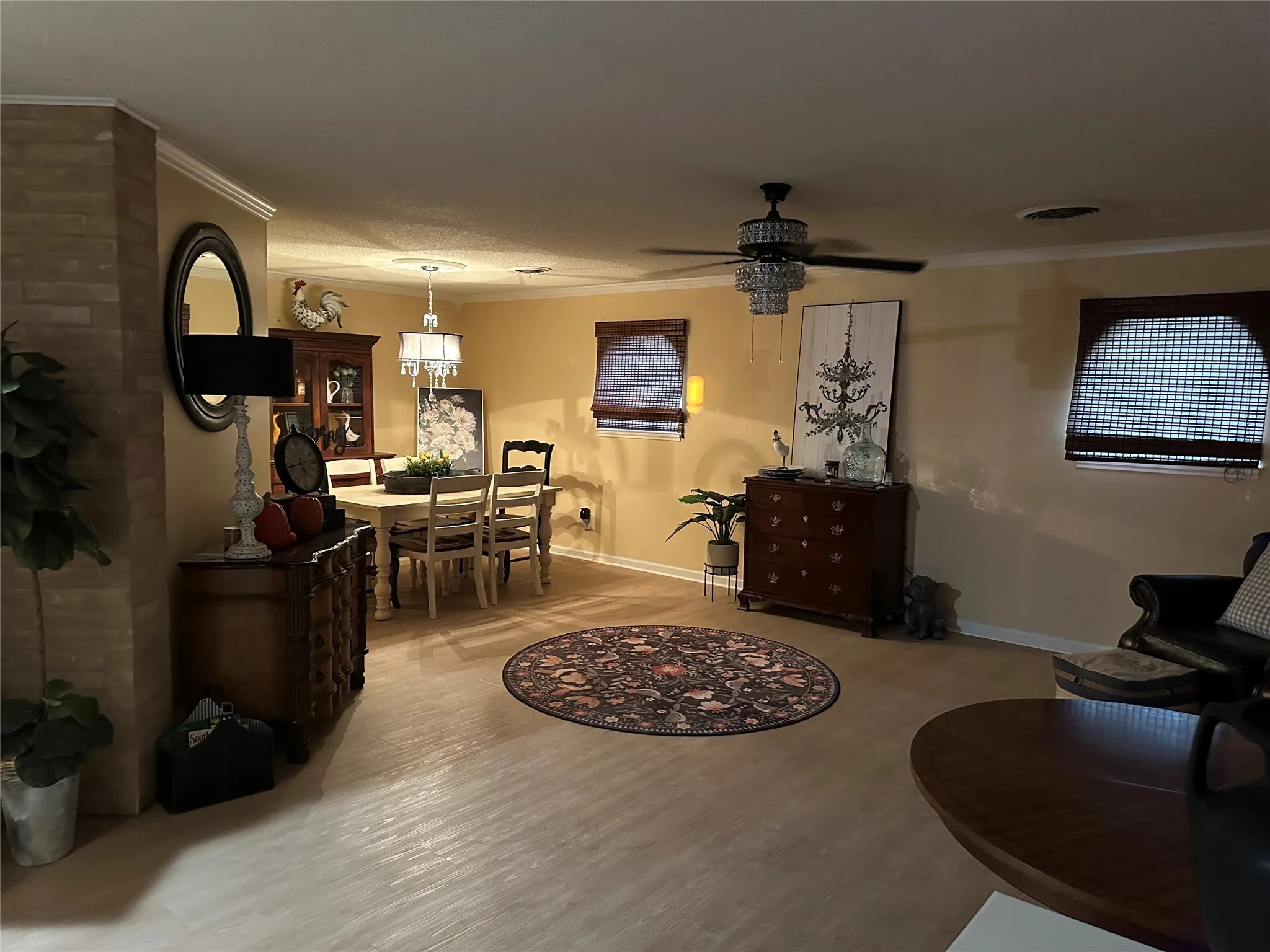 Dining area with ornamental molding and wood finished floors