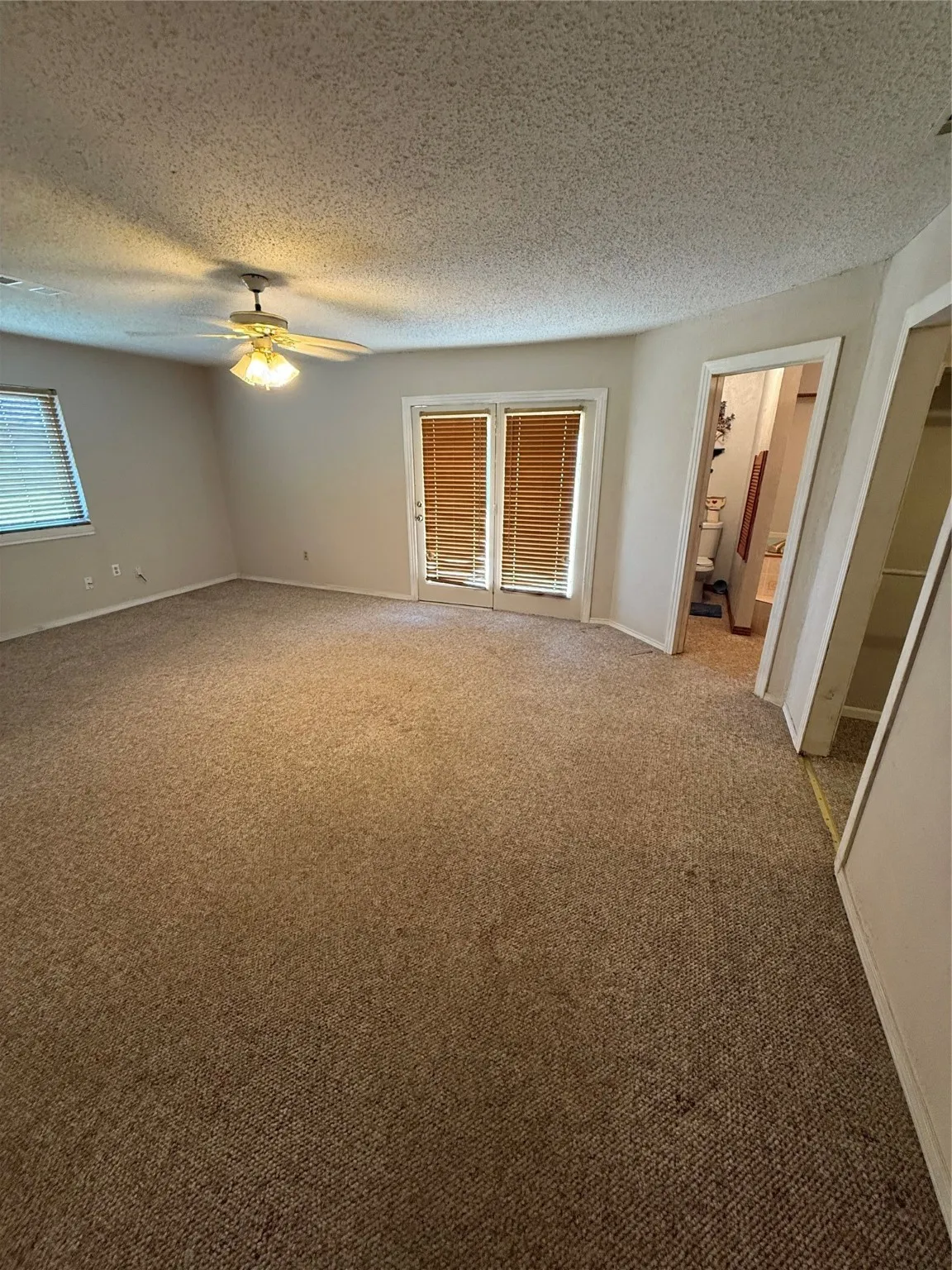 Unfurnished room with carpet floors and a textured ceiling