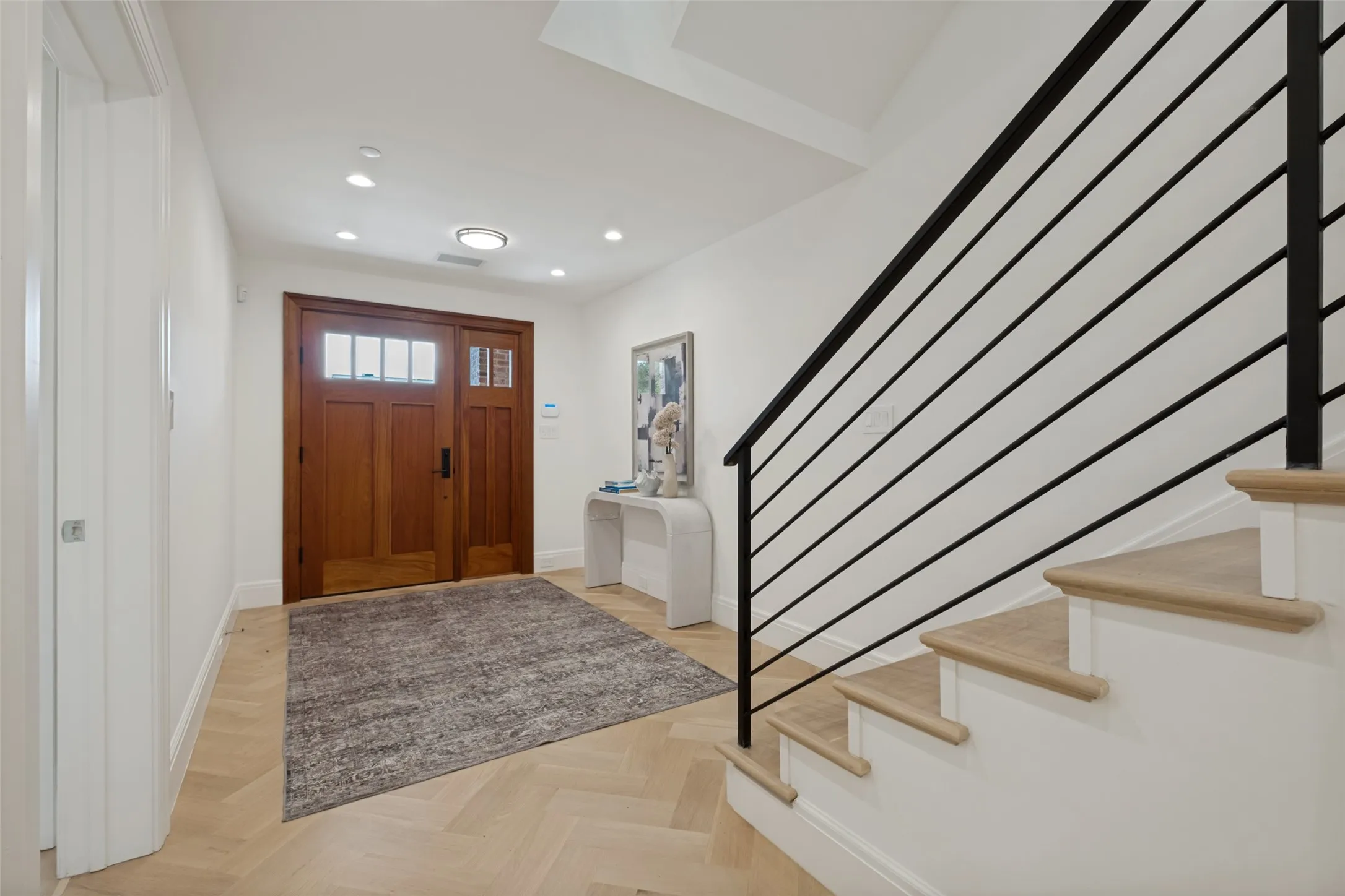 Wide entry way leads way to downstairs bedroom, mudroom, and utility room, along with access to the upstairs living areas.
