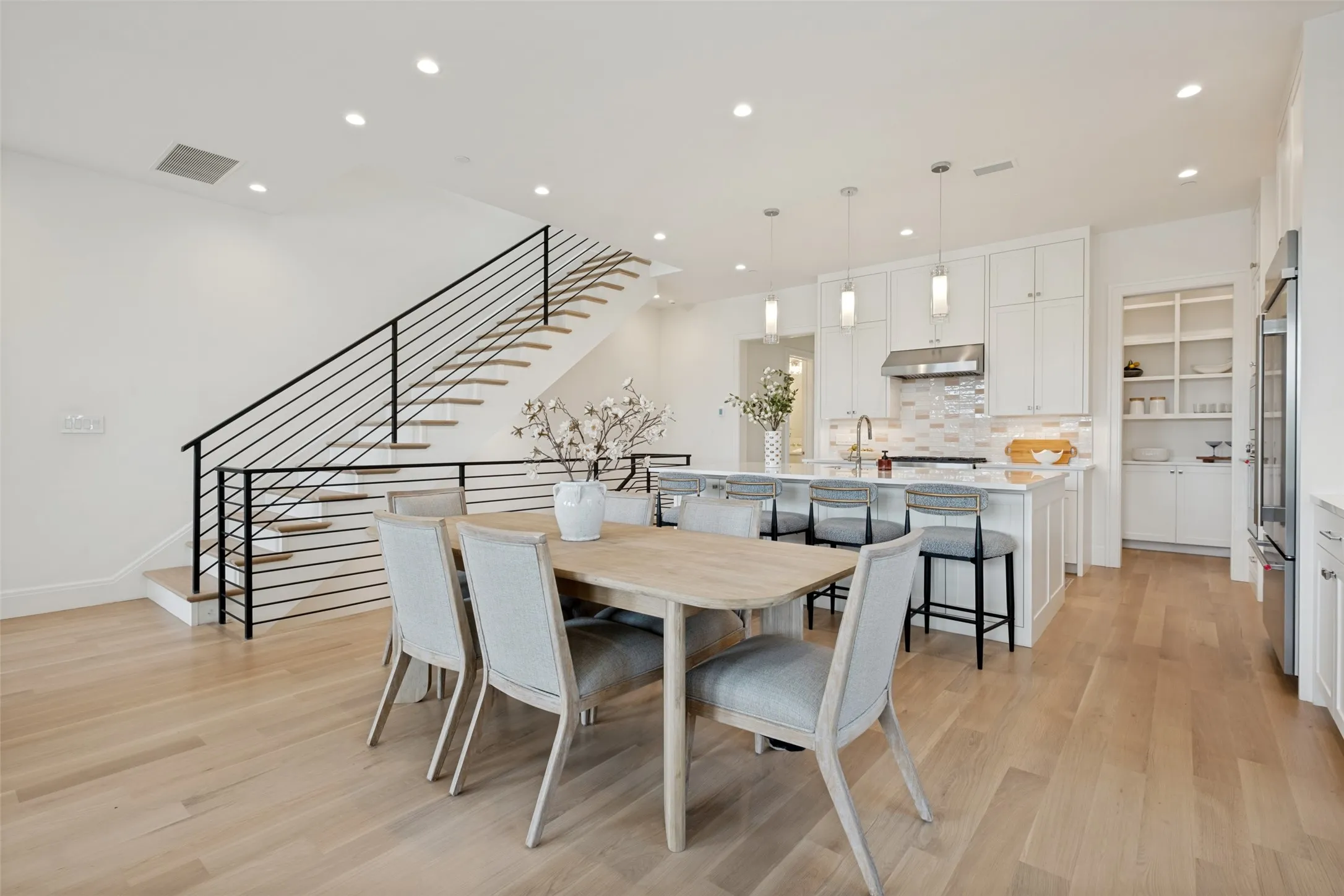 Spacious second floor featuring wide-plank flooring and a dedicated dining area perfect for entertaining friends and family.