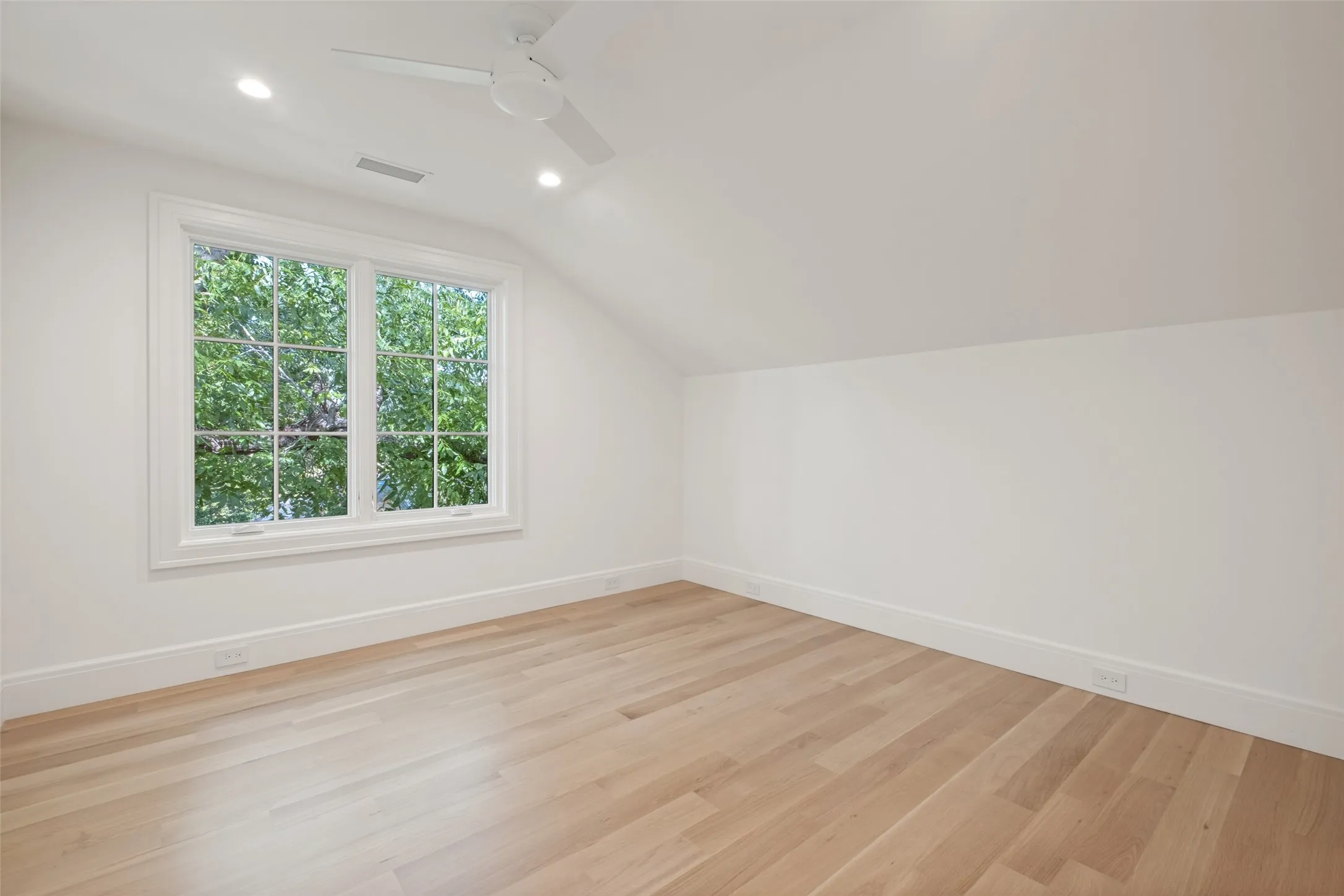 Third-floor bedroom with spacious layout and natural lighting.