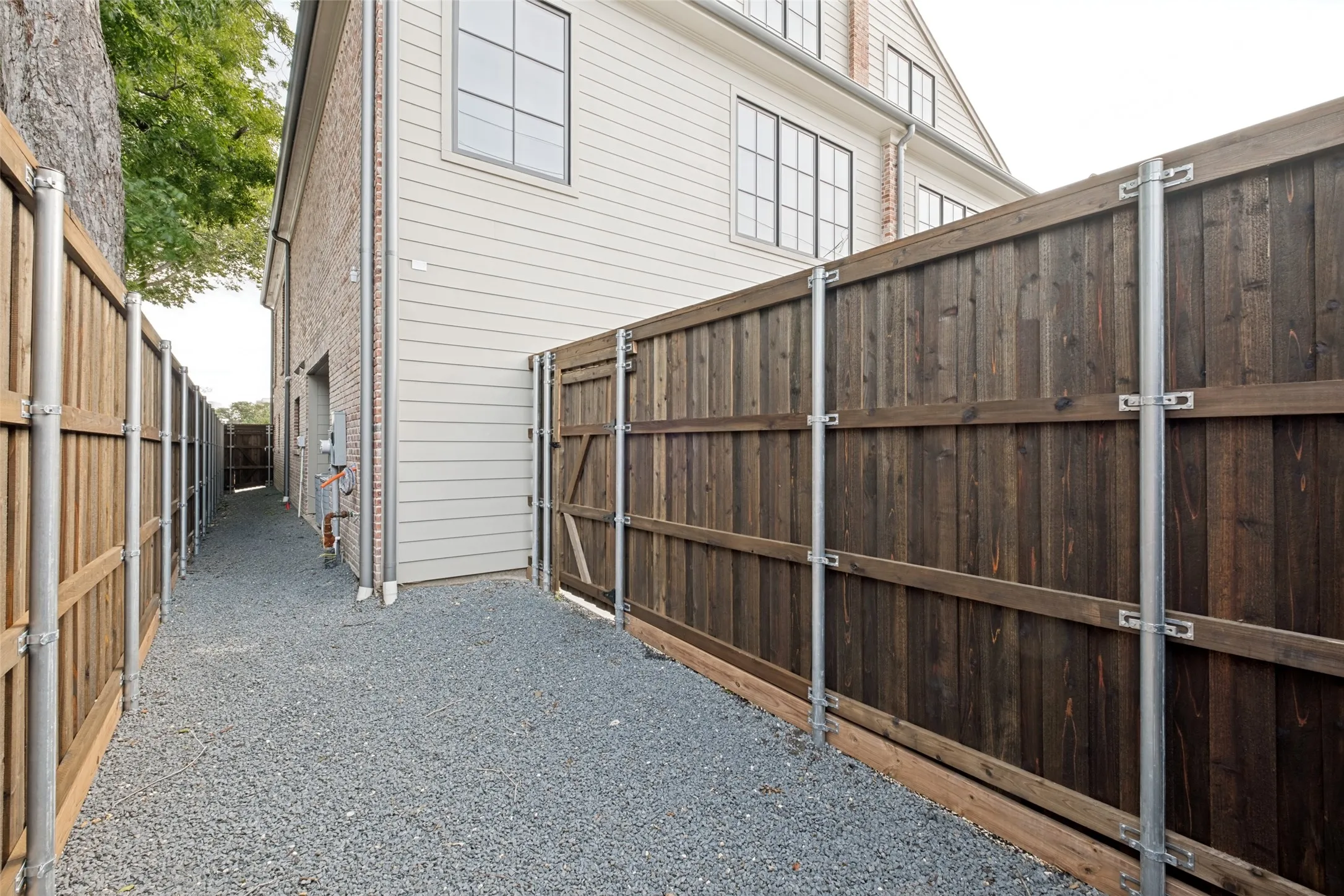 Side yard area perfect for pets, featuring convenient access to and from the garage.