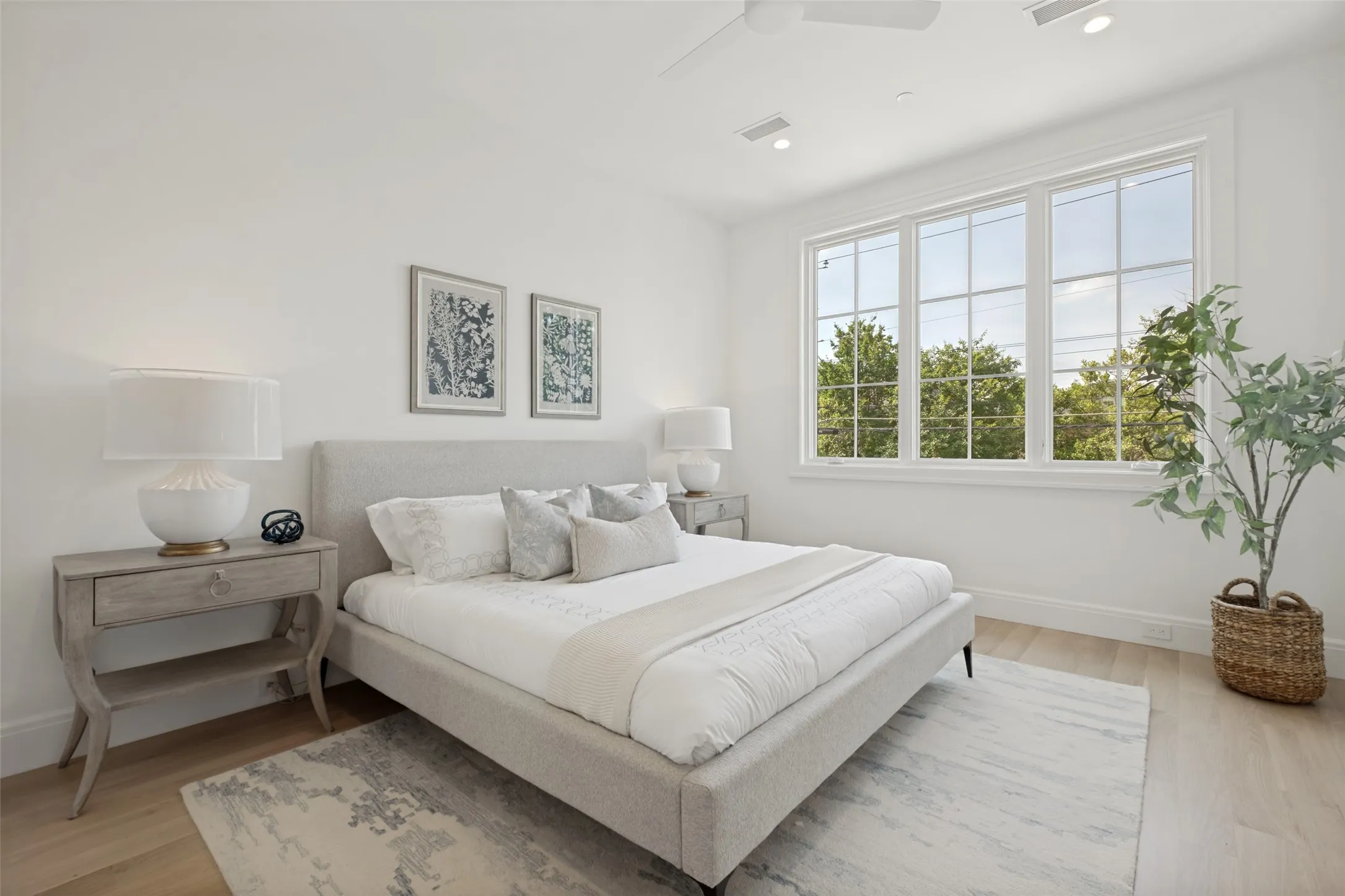 Spacious primary bedroom featuring wide-plank flooring, abundant natural light, and an ensuite bathroom, creating the perfect retreat.