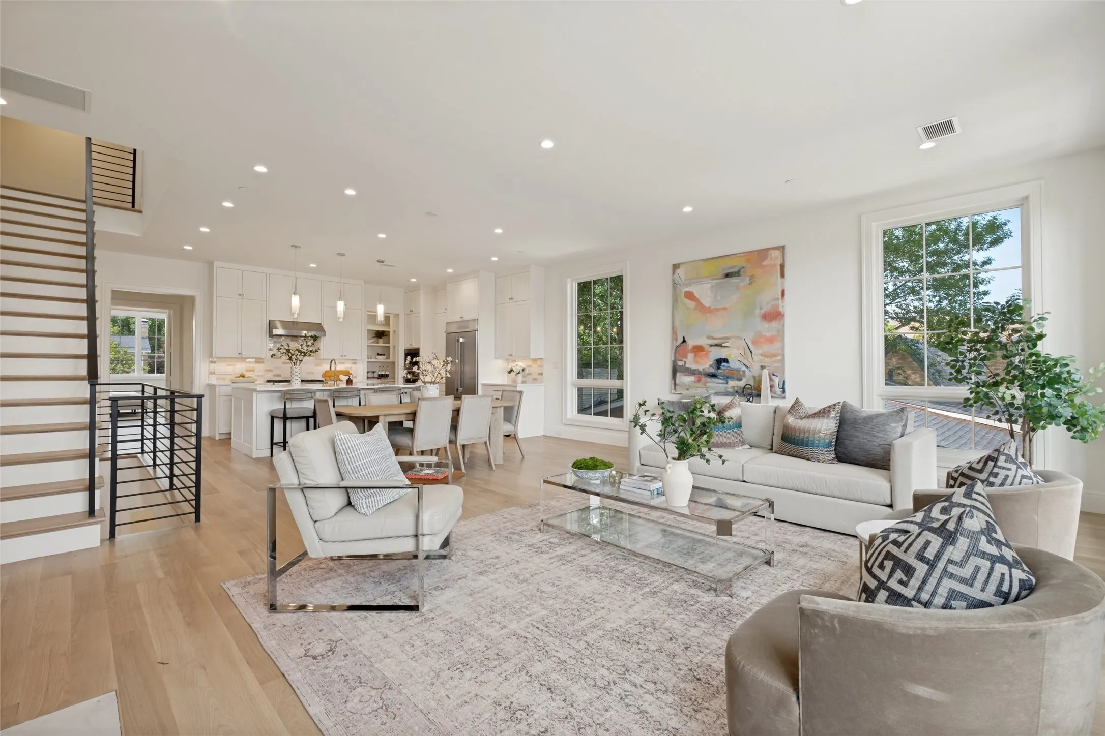 Open-concept layout featuring a view of the second-floor living spaces and staircase access to the third-floor bedrooms.