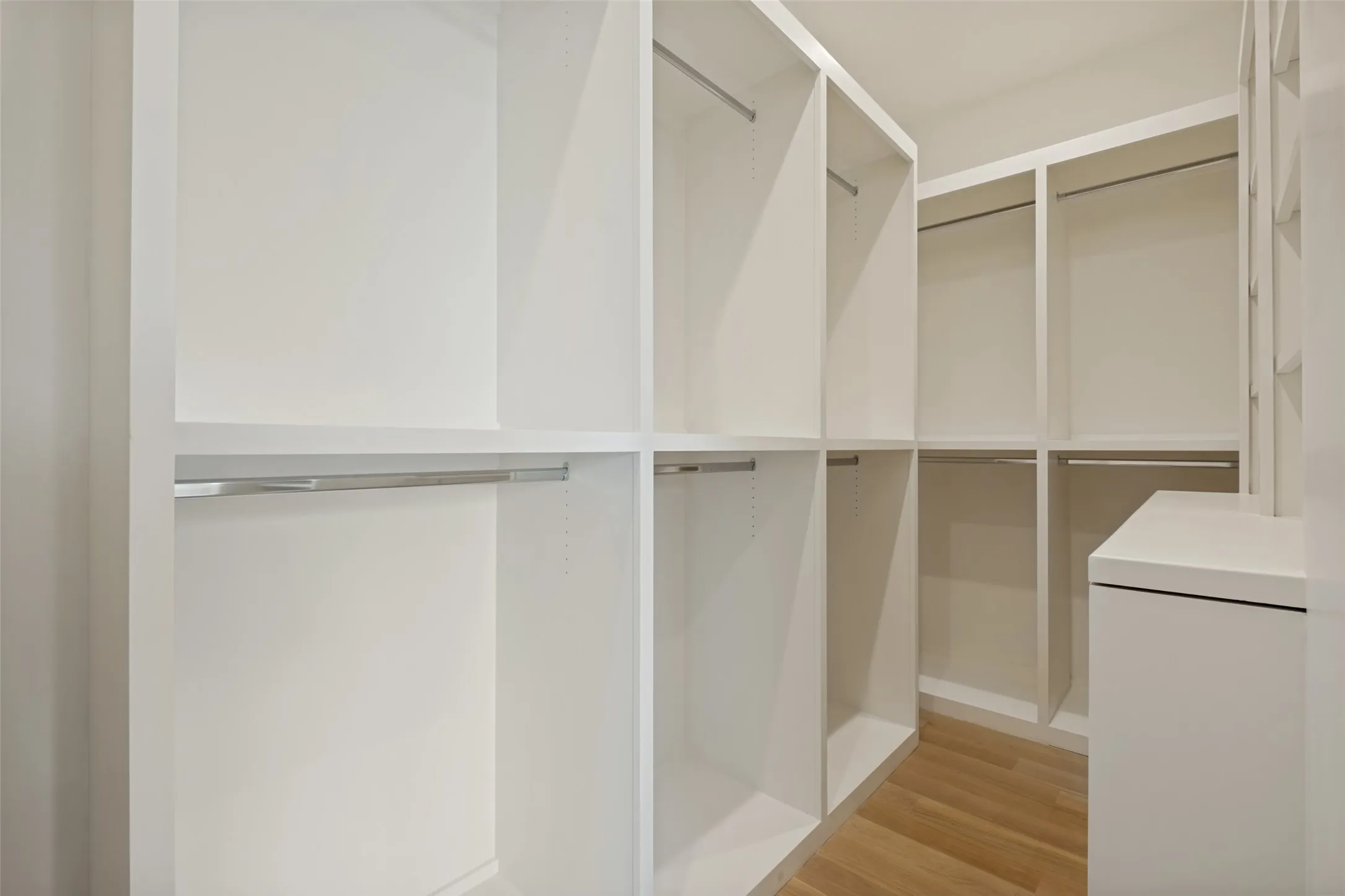 Generously sized primary closet featuring custom built-ins and organized storage solutions.