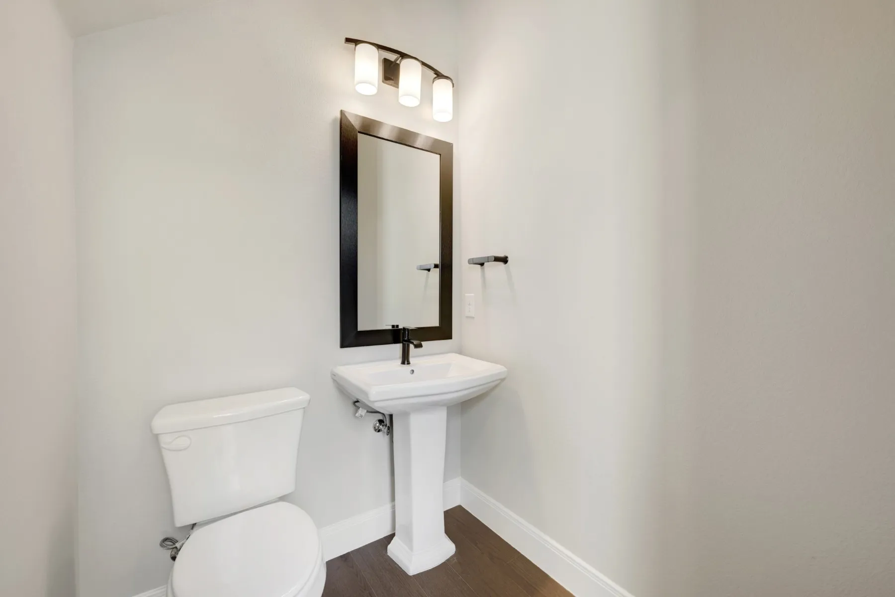 Bathroom with toilet and dark wood-type flooring