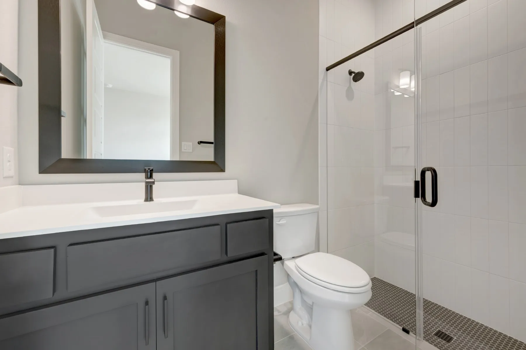 Full bathroom with vanity, a stall shower, and light tile patterned floors