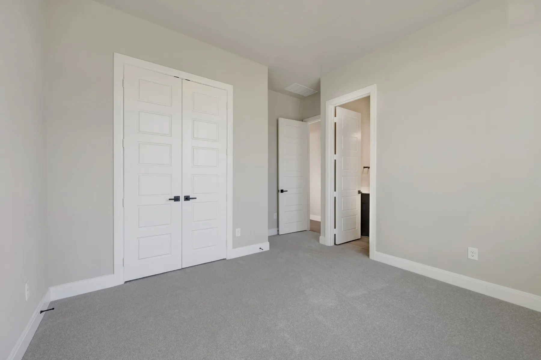 Unfurnished bedroom featuring light carpet and a closet