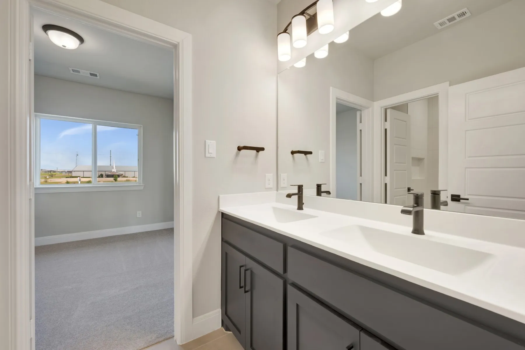 Full bathroom with double vanity and light colored carpet