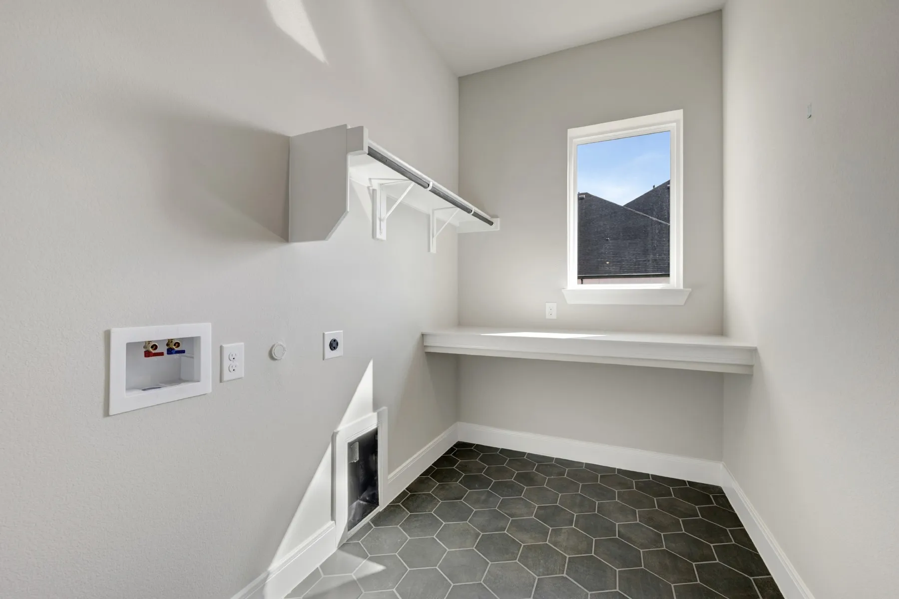 Laundry room featuring hookup for a gas dryer, hookup for a washing machine, dark tile patterned flooring, and hookup for an electric dryer