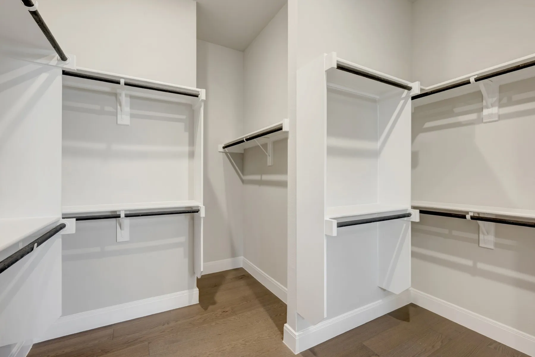 Walk in closet with light wood-style flooring