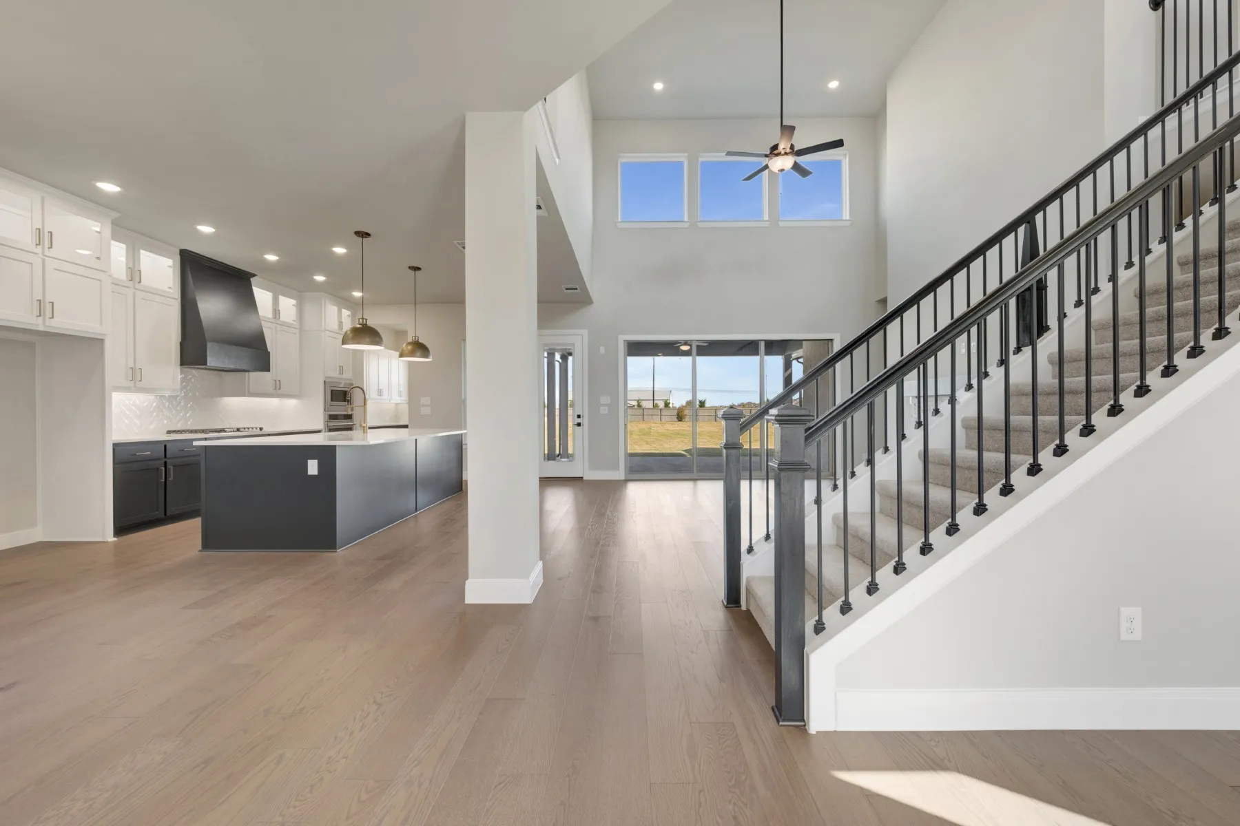 Entryway with light wood-type flooring, a high ceiling, recessed lighting, and ceiling fan