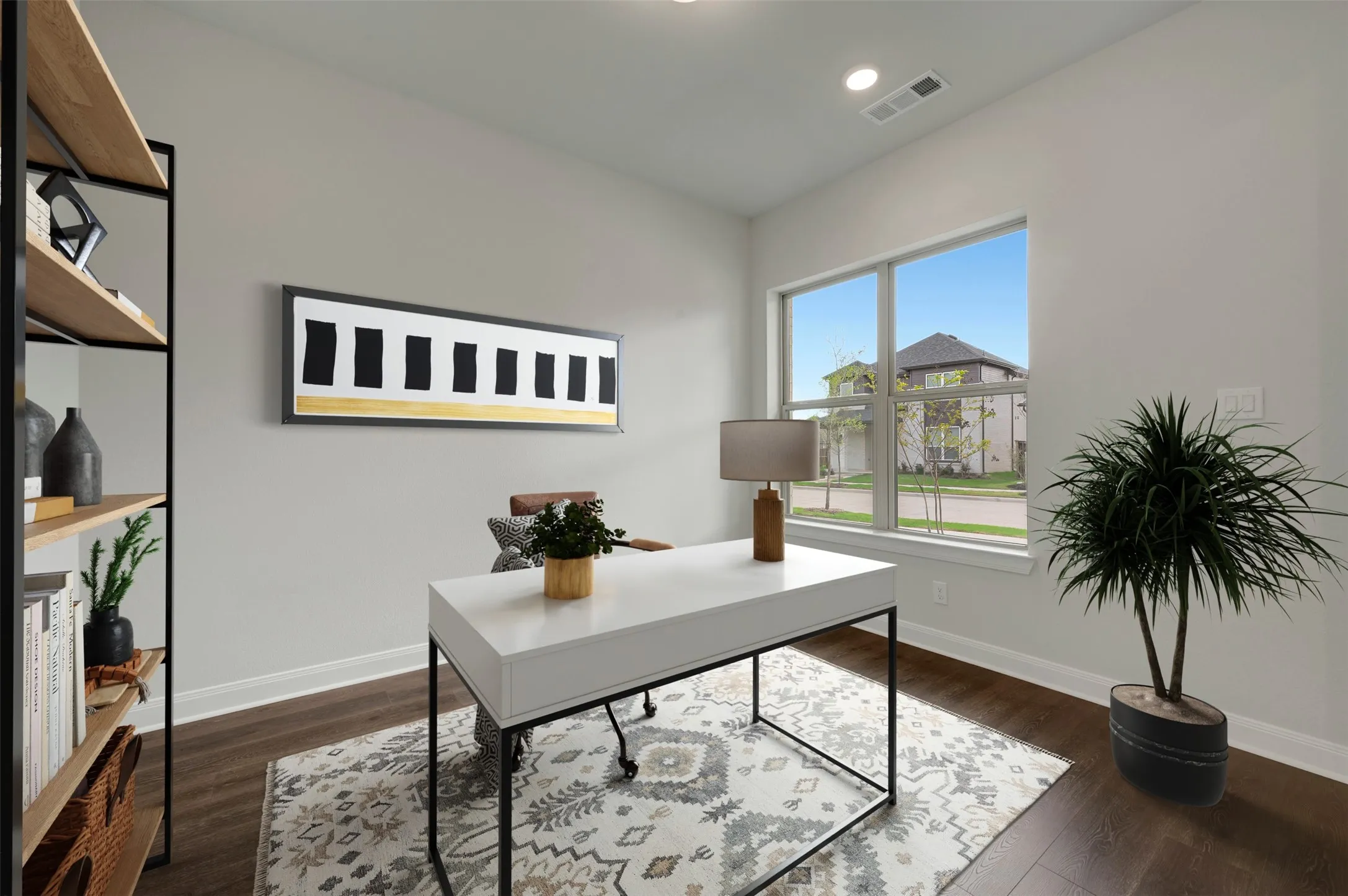 Home office with dark wood-style floors and recessed lighting