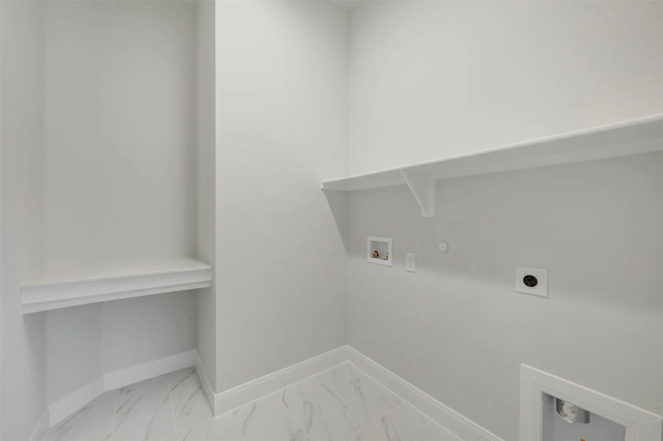 Laundry area featuring hookup for a gas dryer, hookup for a washing machine, hookup for an electric dryer, and light marble finish floors