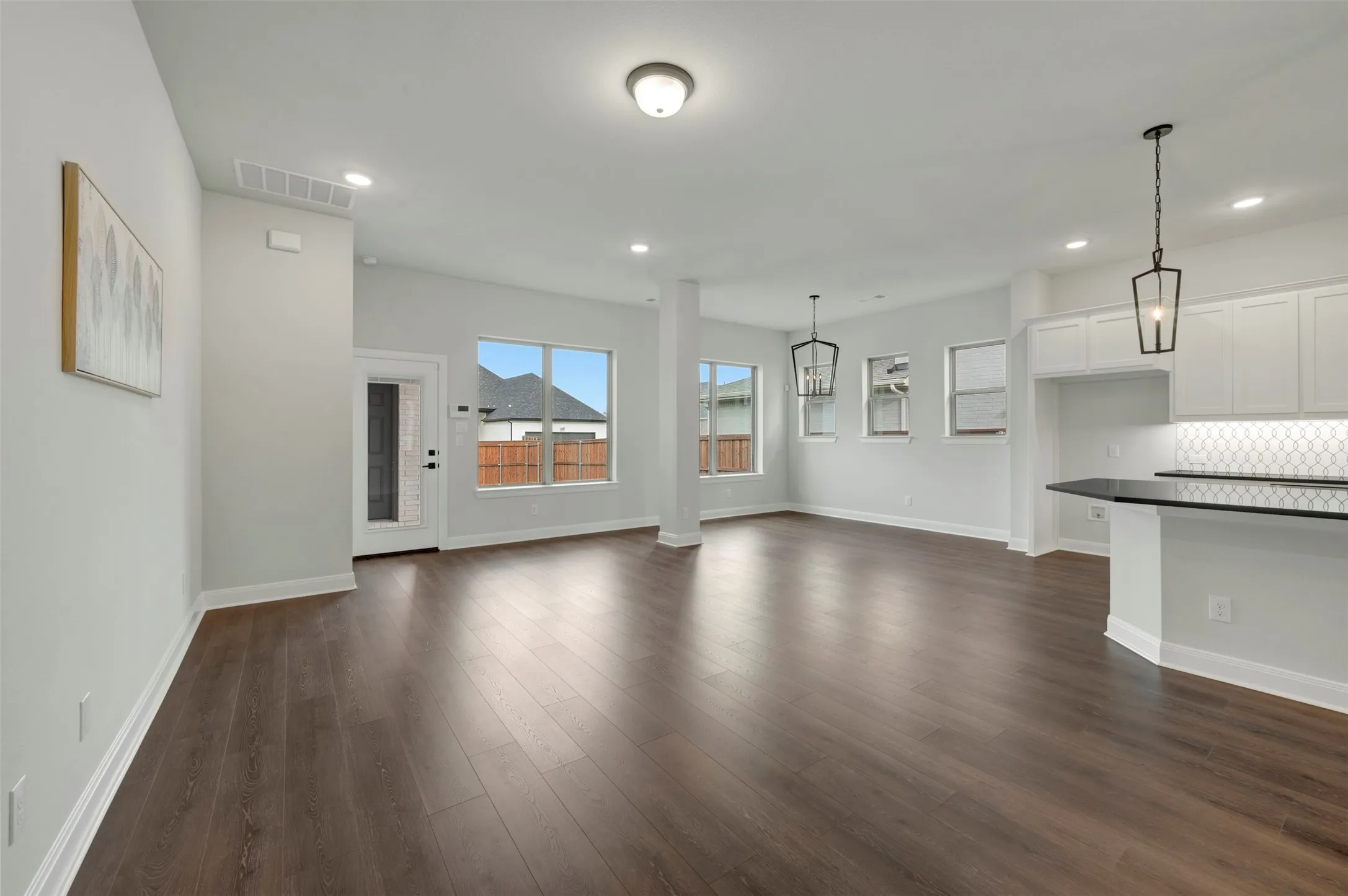 Unfurnished living room featuring dark wood finished floors and recessed lighting