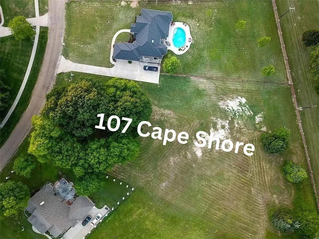 Aerial view of property and surrounding area featuring a pool