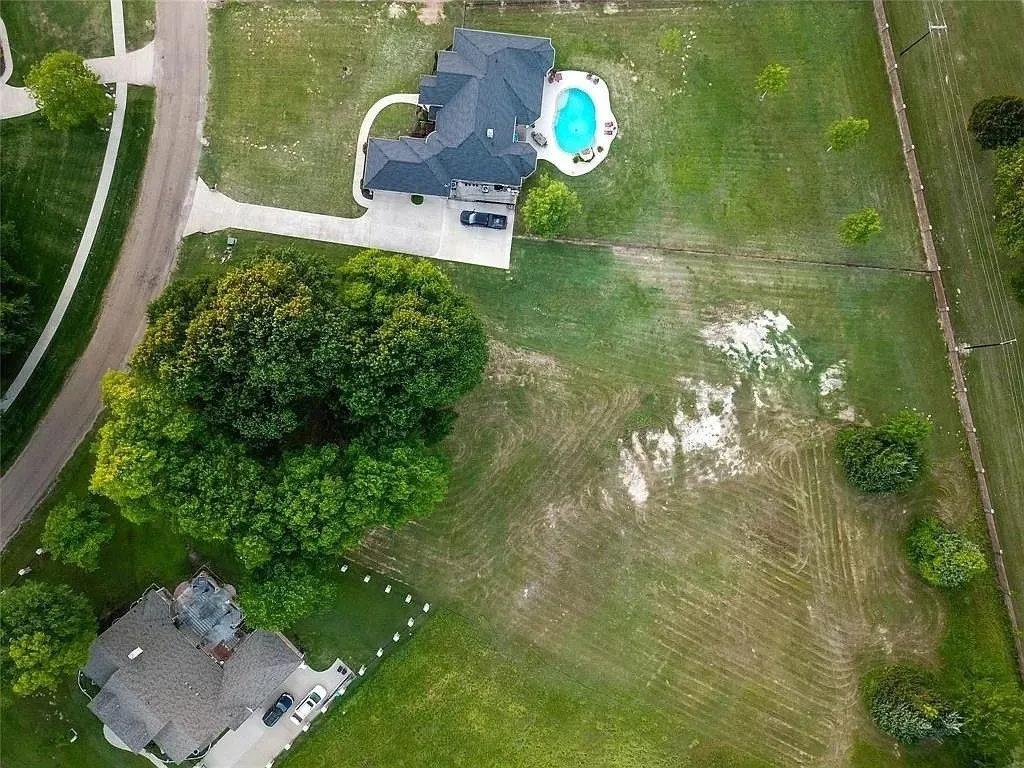 Aerial overview of property's location featuring a pool area