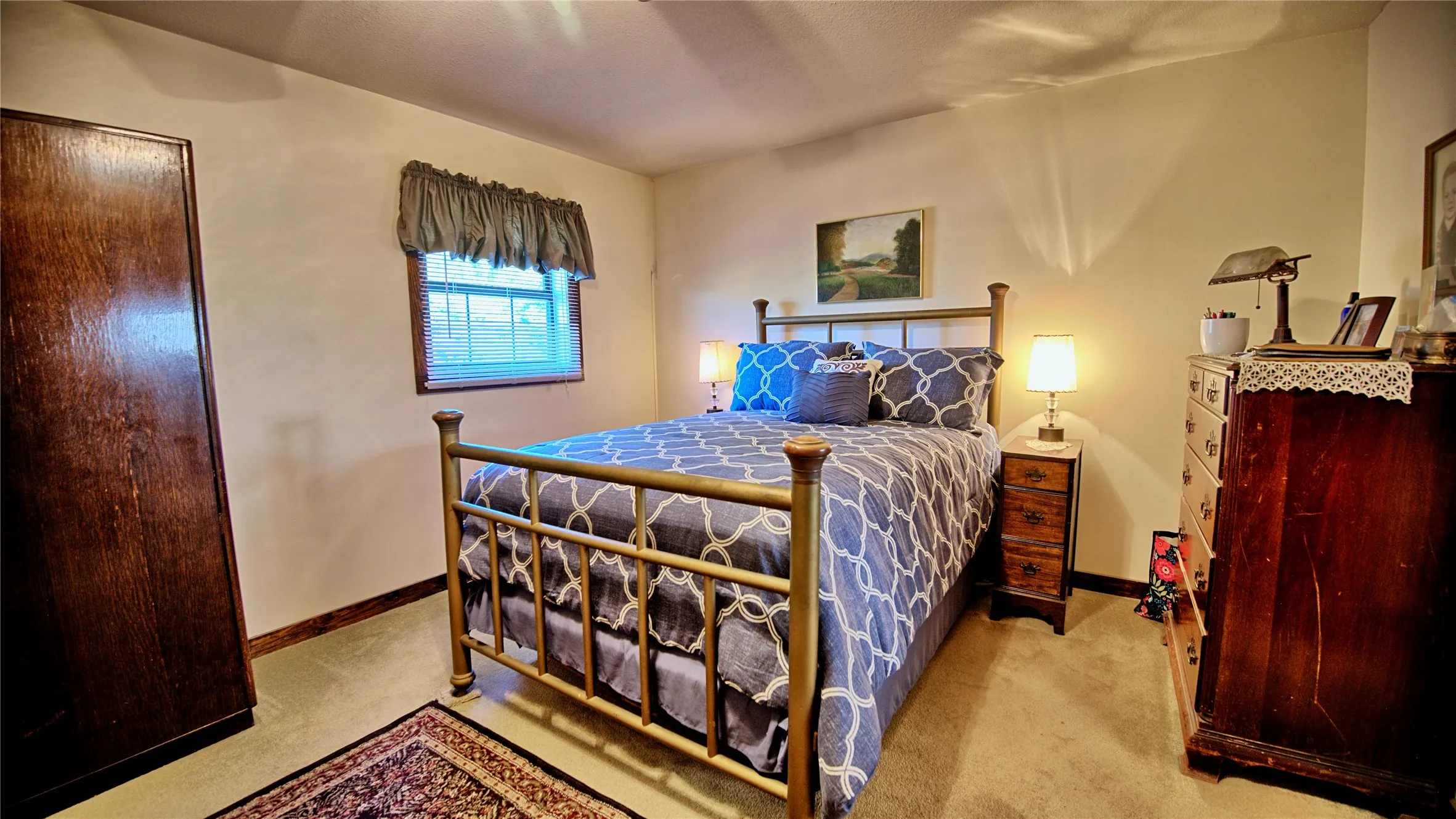 Bedroom with baseboards and light colored carpet