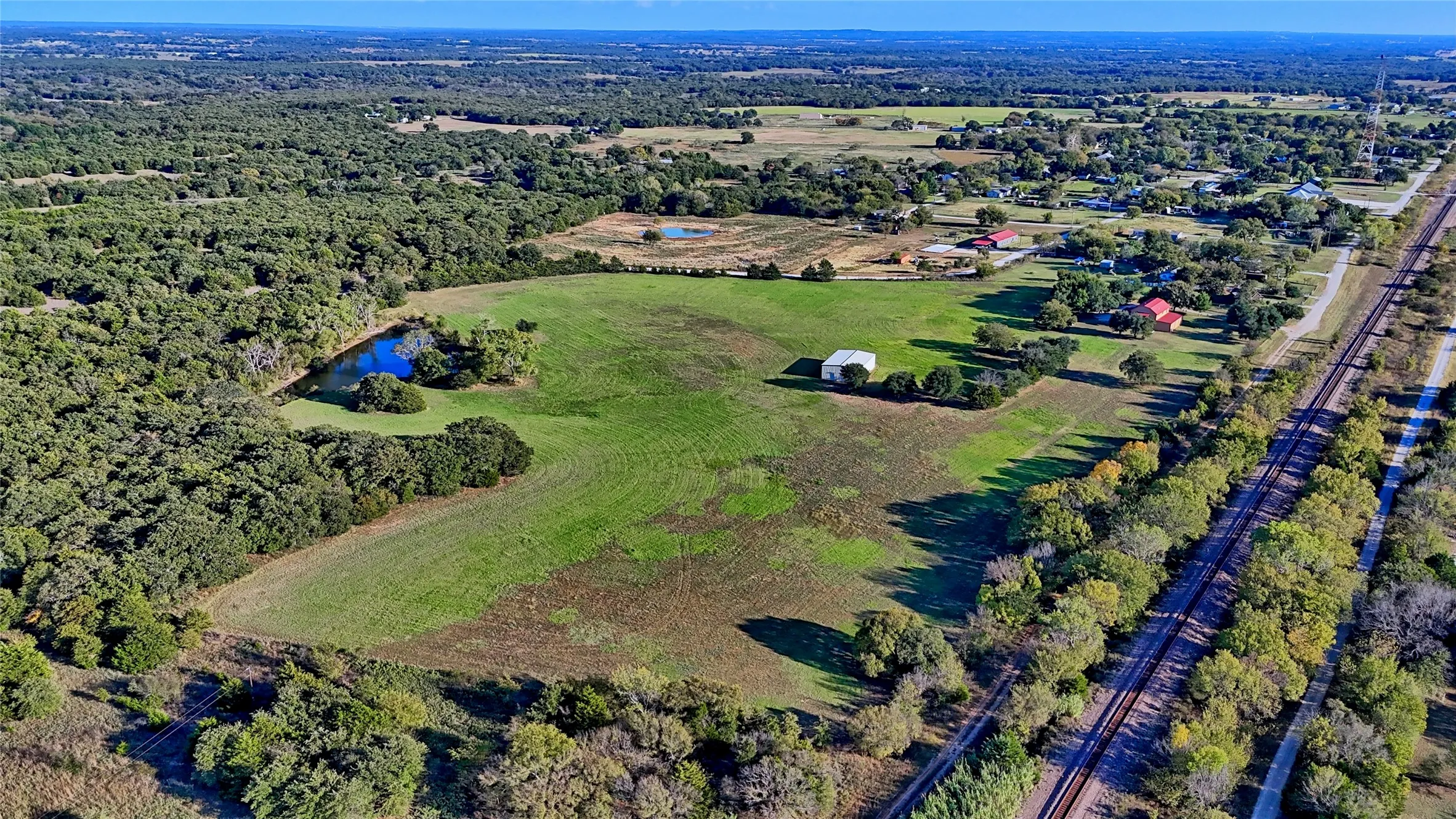 Aerial view of property's location with a nearby body of water
