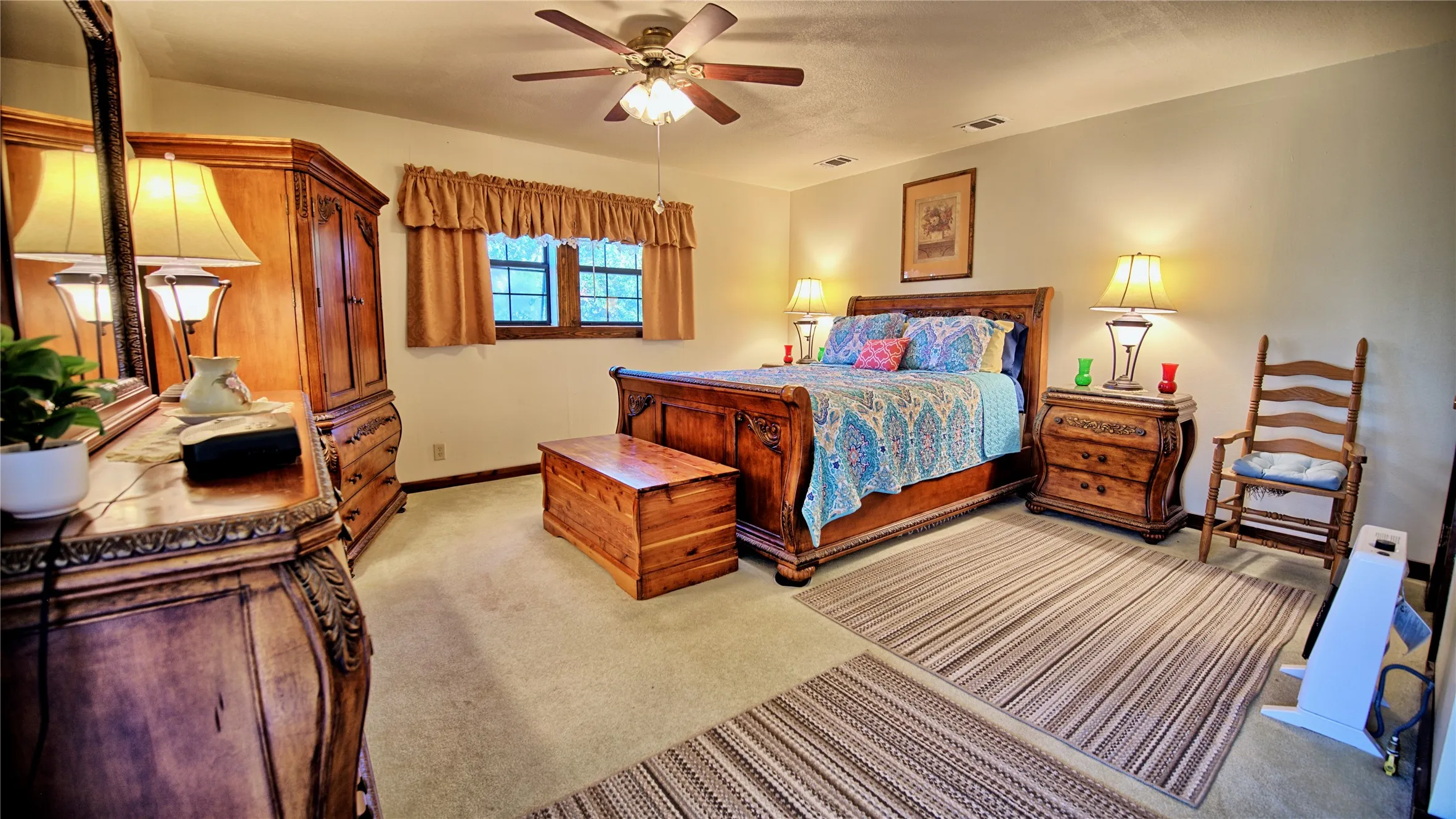 Bedroom with light carpet and ceiling fan