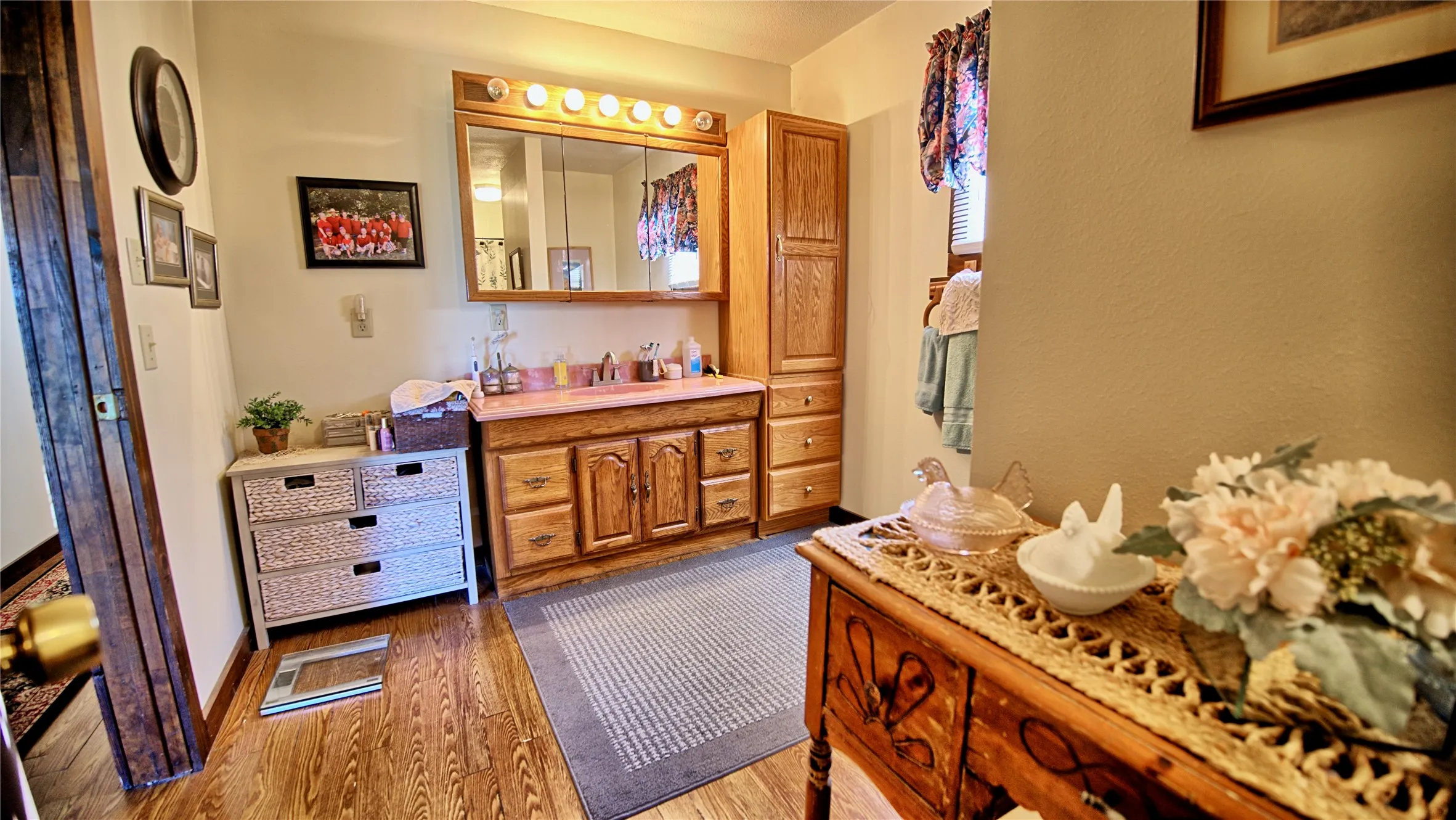 Bathroom featuring vanity and dark wood finished floors