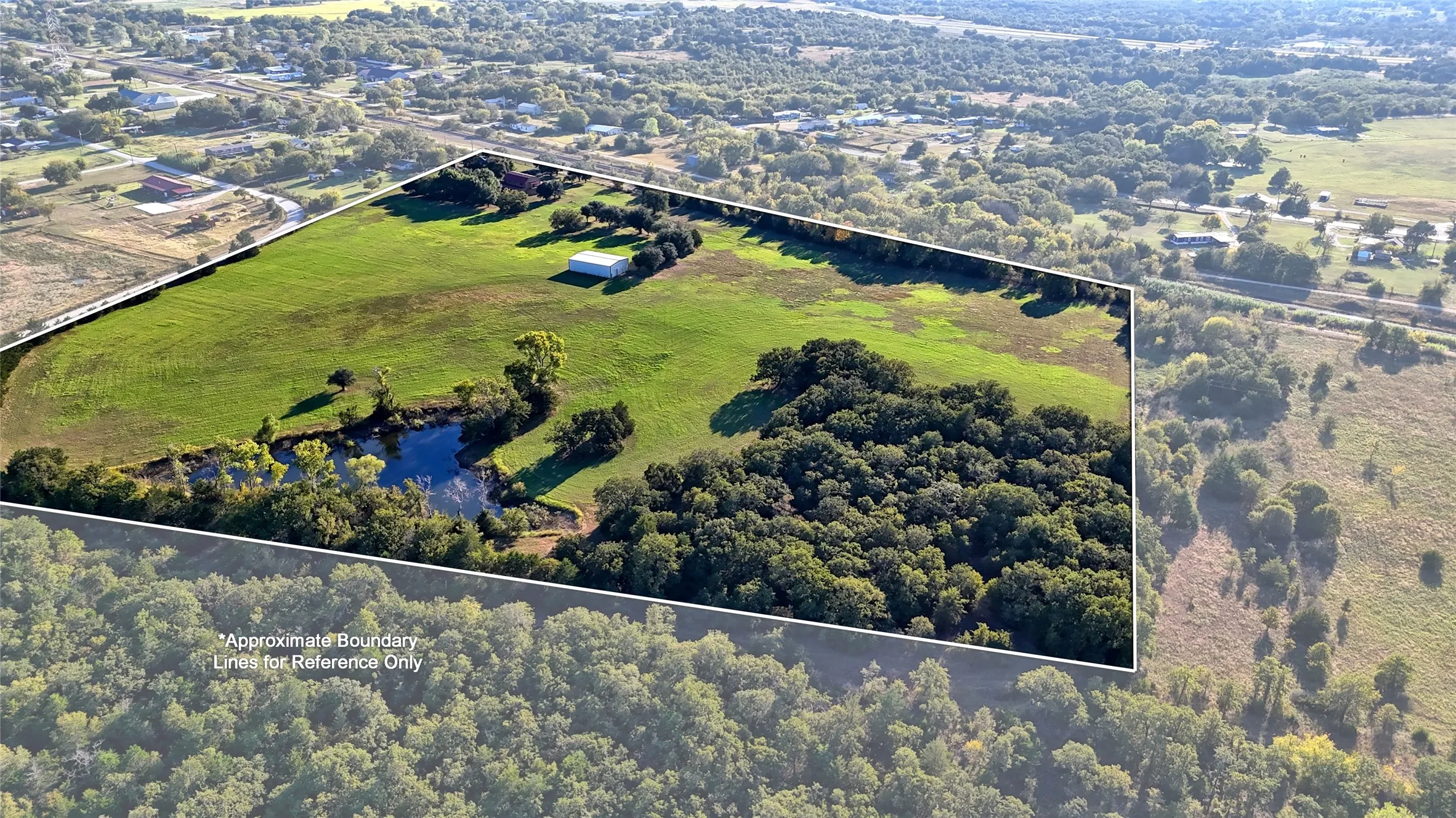 Aerial view of property and surrounding area featuring a large body of water and property boundaries highlighted