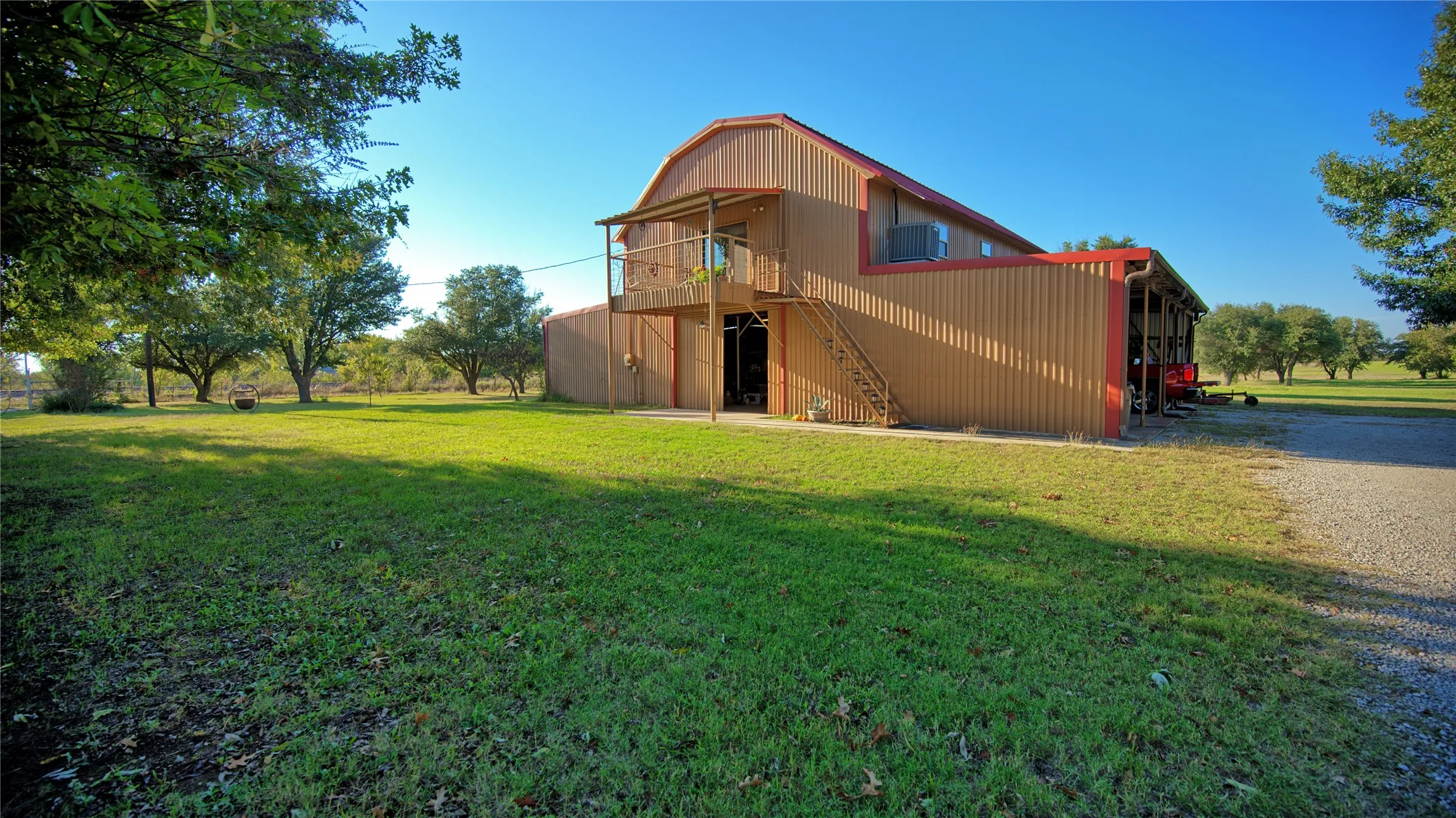 Rear view of property with stairway, a balcony, and a yard