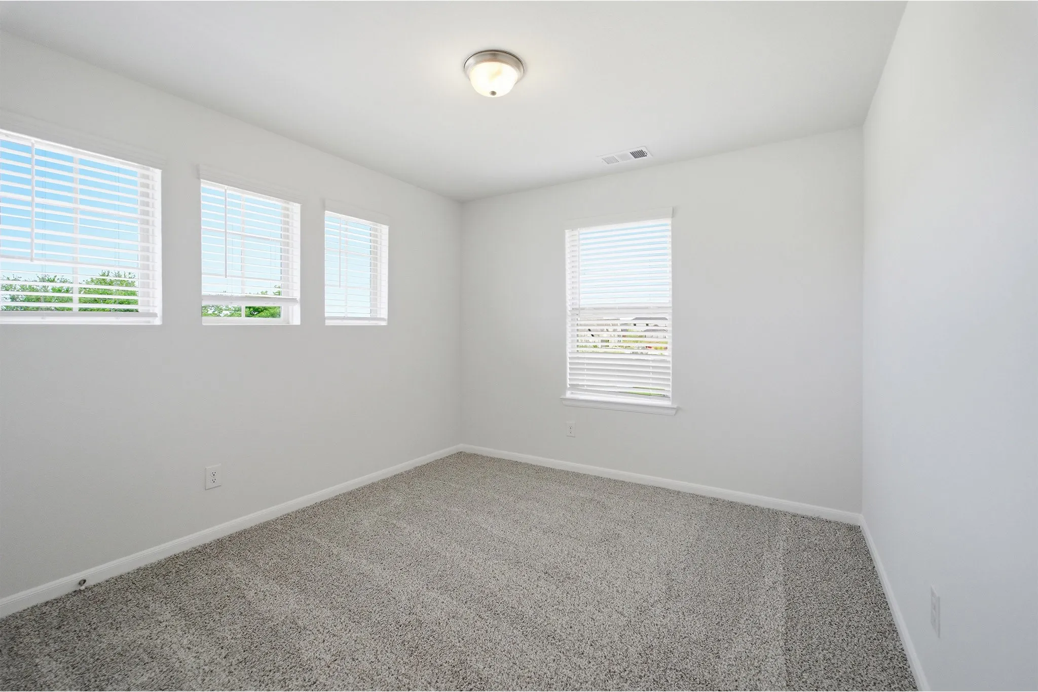 Room featuring light gray carpet flooring and white painted walls