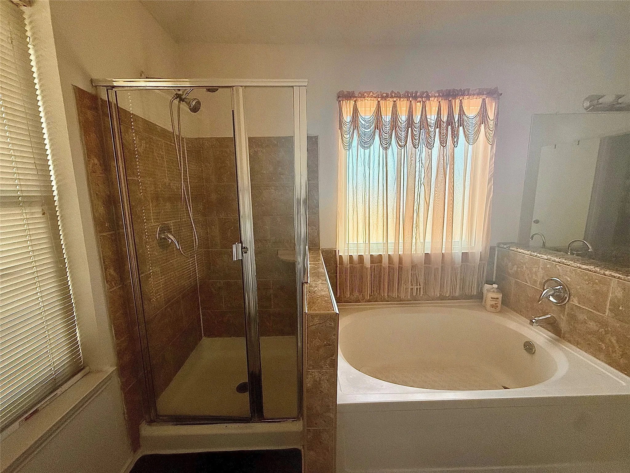 Full bathroom featuring a shower stall and a bath