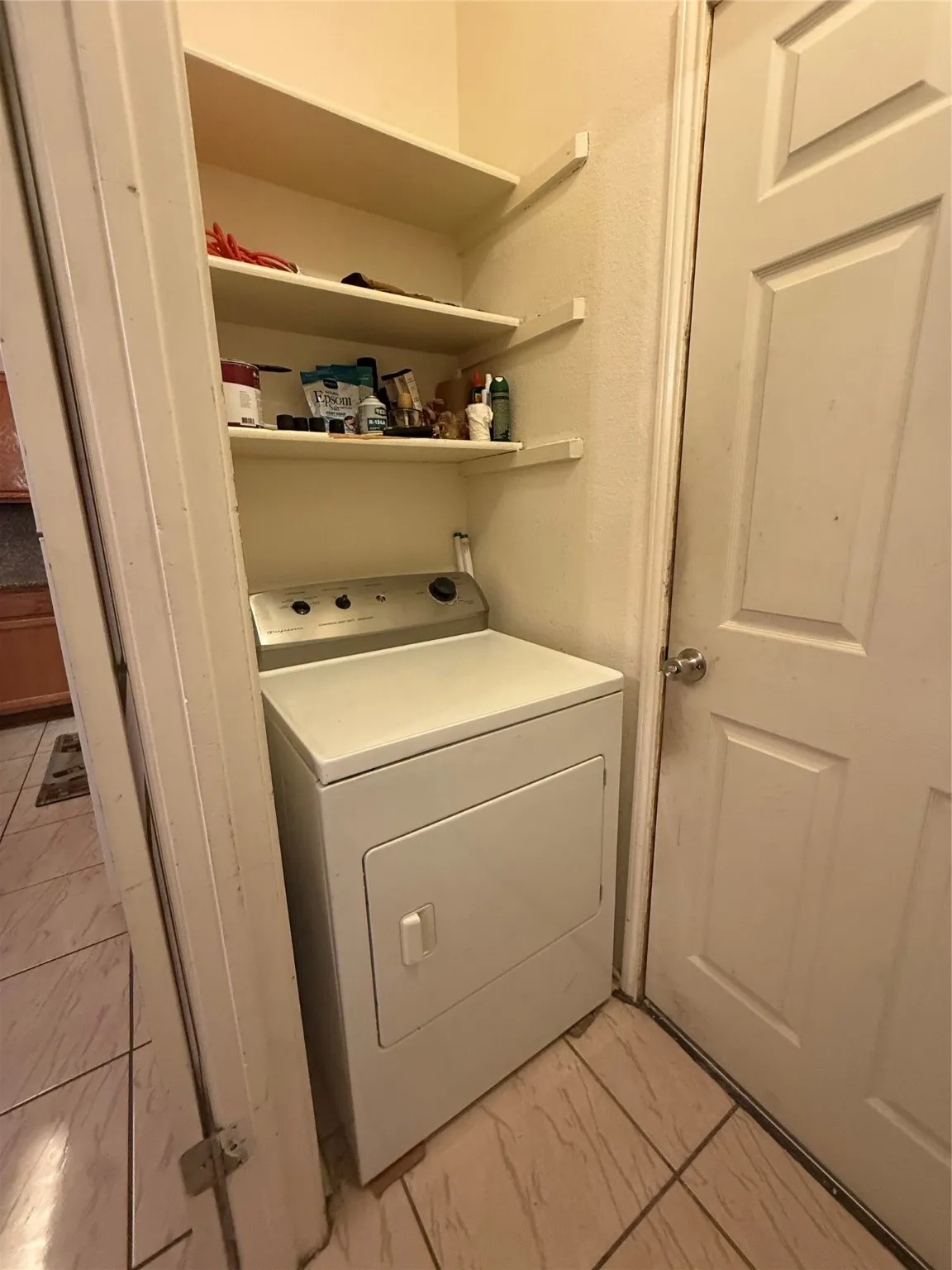 Washroom with washer / dryer and light marble finish floors