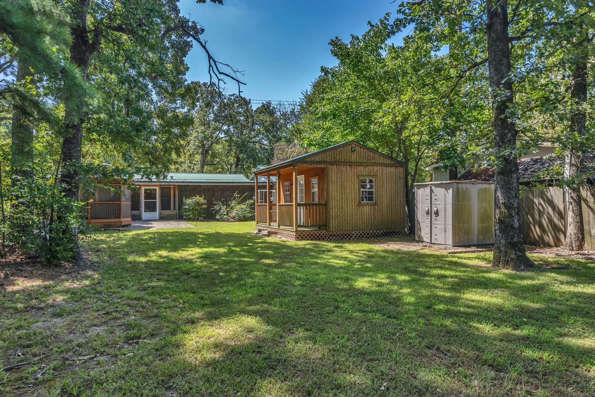 View of grassy yard with outbuilding and gazebo